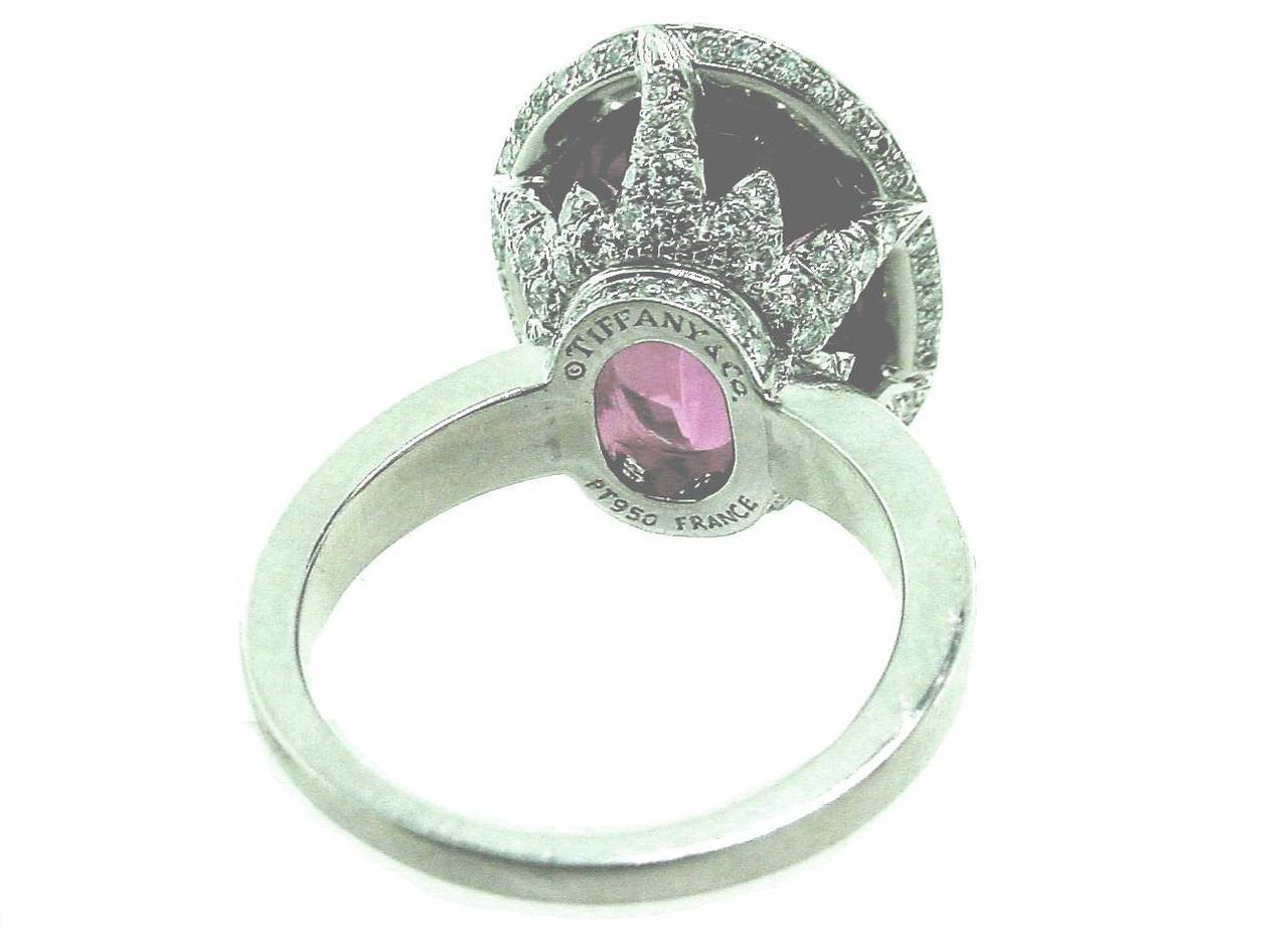 This is an incredibly beautiful platinum diamond ring by Tiffany & Co. France.  It features a 12ct oval faceted pink tourmaline with approximately 2cts  of  fine  diamonds. Diamonds are G color, VS1 clarity.
  
Ring is size 6 and weighs 15.3