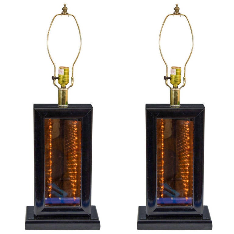 A vintage pair of infinity lamps with smoked glass and black lacquered base. Good vintage condition with age appropriate wear. Some nicks and scratches to lacquer. Shades not included.

7512