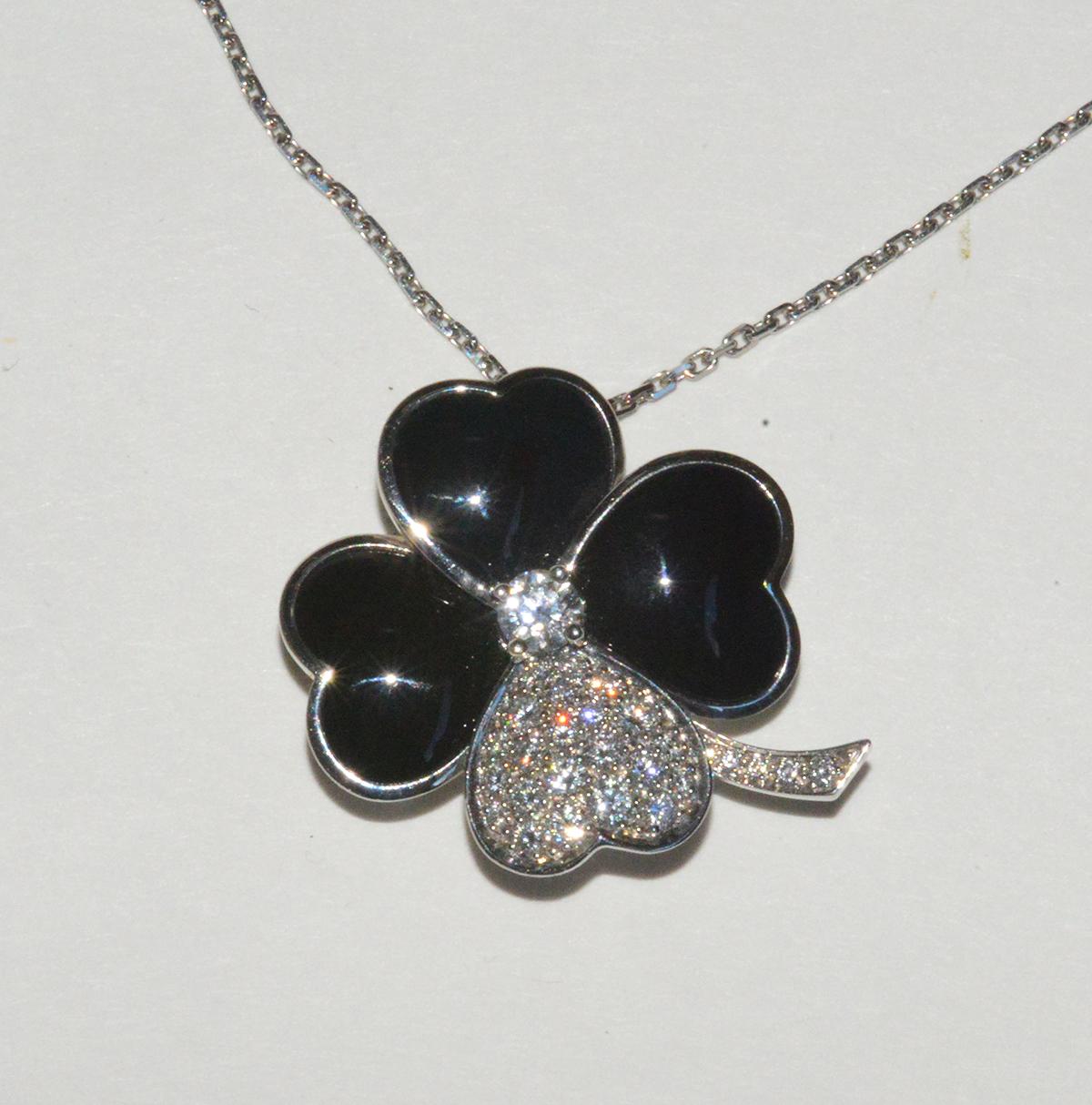 This is a most magnificent, rare, discontinued VCA flower/clover pin/pendant in 18K white gold. There are 3, heart shaped petals and one all diamond pave heart shaped petal. There is a diamond center. This is the largest clover pendant VCA makes. 