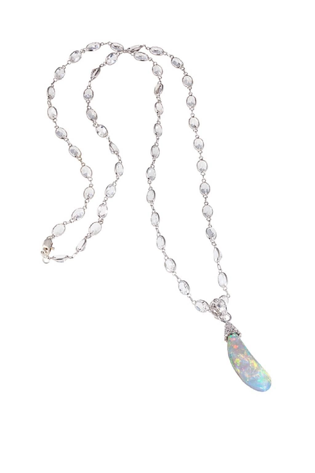 This delicate opal drop is nestled in a 18K White Gold diamond encrusted cap suspended on an 18 inch White Topaz chain. 9.61ct Lightning Ridge Opal with 0.26ct Diamonds.