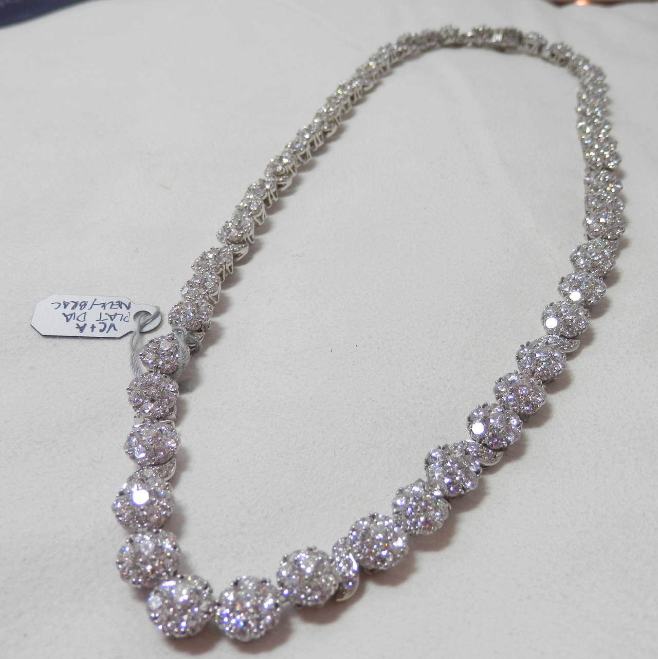 18K white gold this is a cluster necklace with 398 fine white diamonds (F/VVS)  There are approx. 38 cts.  It is signed Van Cleef & Arpels and also numbered NY62307  It is wearable in the length shown or shortened it can be a choker or a pair of