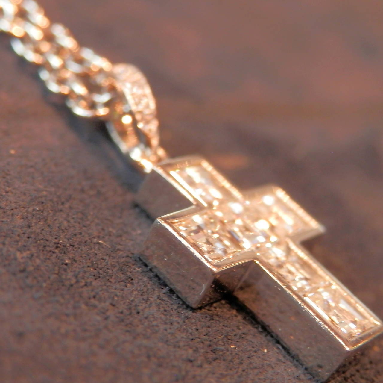 Platinum pendant and chain, both signed by Cartier.  The cross is set with 6 fine square cut diamonds (G/VVS2).  These diamonds are approx. .25 cts each with a total diamond weight of approx. 1.50 cts.  Both chain and cross are signed.  Cross is 1