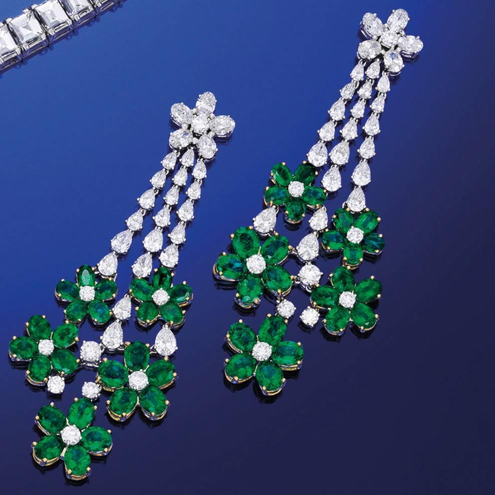 12.11 cts of fine vivid green emeralds, and 6.48 cts. of fine white diamonds, all come together to create these lovely ear pendants.  The earrings are slightly articulated to create a twinkle as the light catches the stones.  These contemporary