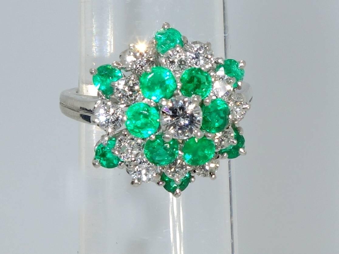 This platinum ring is made by the world famous firm of Oscar Heyman & Bros.  Signed and numbered, it possesses 13 diamonds weighing 1.05 cts and 12 Colombian emeralds weighing .95 cts. The diamonds are all F/G color (colorless to slightly