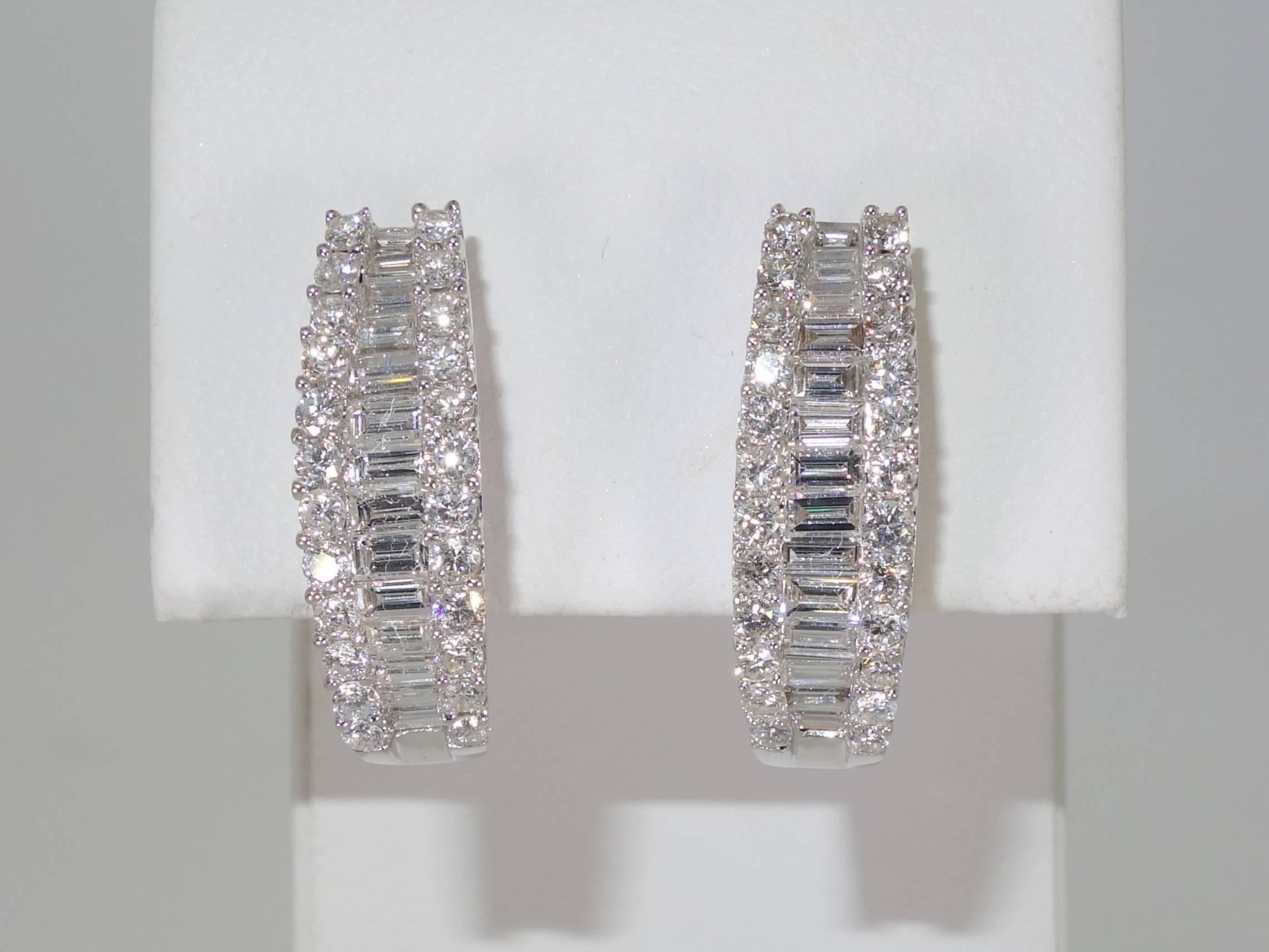 18K white gold possessing 2.20 cts.  These diamonds are white and clean! (near colorless G/H and very slightly included).  There are 28 baguette cut diamonds in the center and 48 round modern brilliant cut diamonds on the edges.  The earrings are