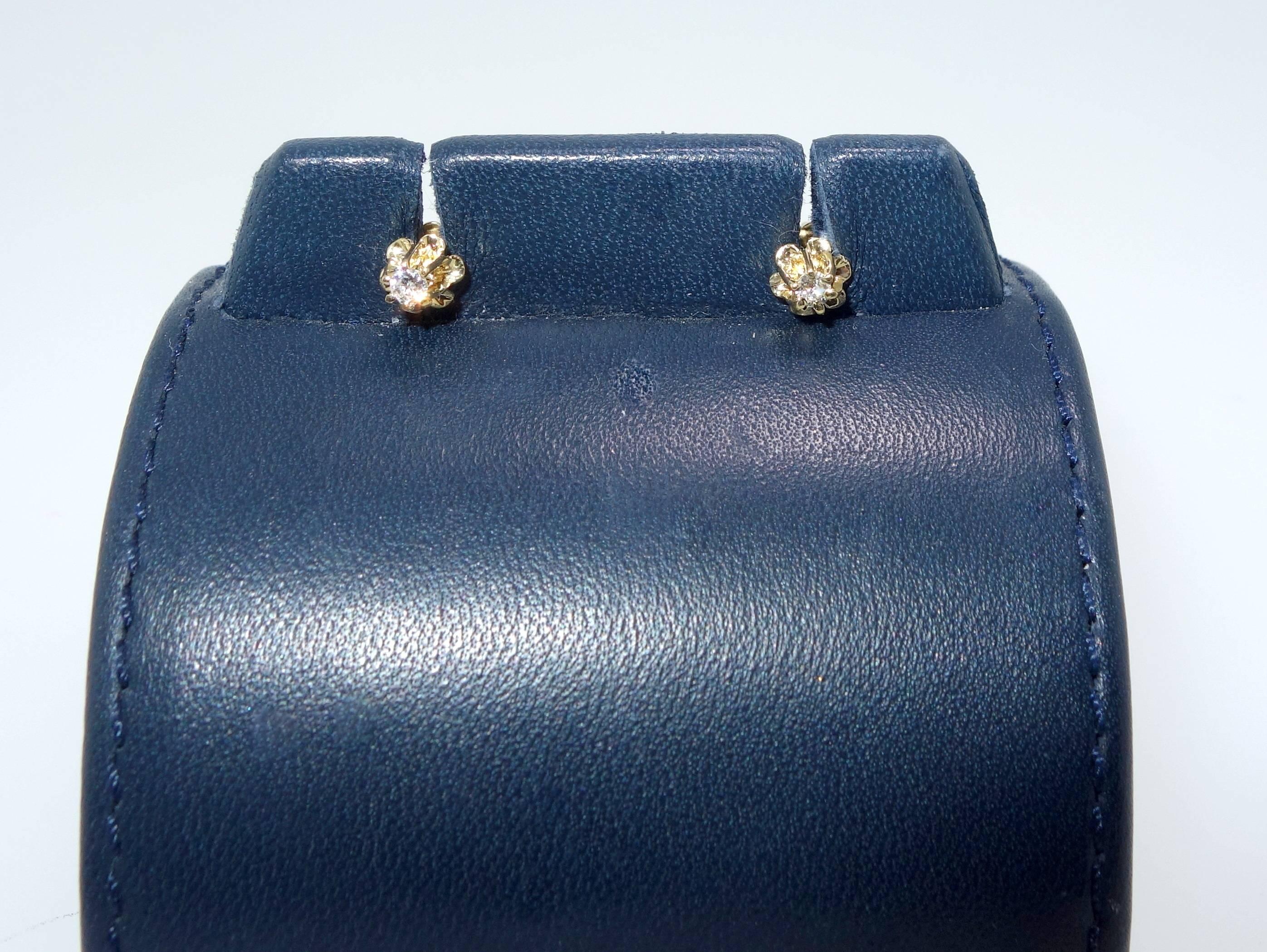 14K yellow gold buttercup diamond stud earrings with a total diamond weight of .10 cts.  Small but very cute.