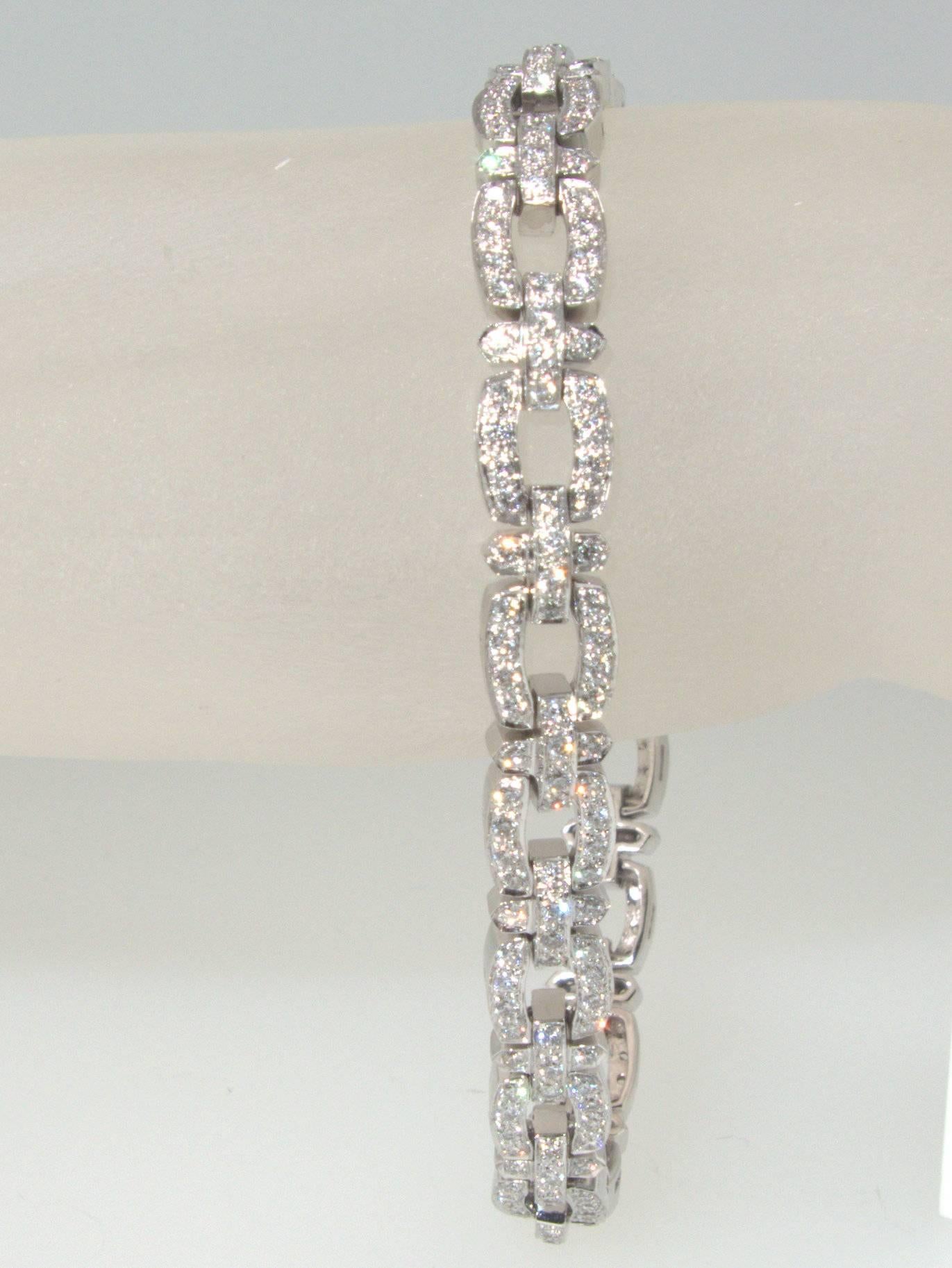 18K white gold links hold 252 fine, well matched, modern brilliant cut diamonds all near colorless (H) and very slightly included (VS). j There are approximately 5 cts totally.  This highly wearable bracelet is just over 7 inches long.