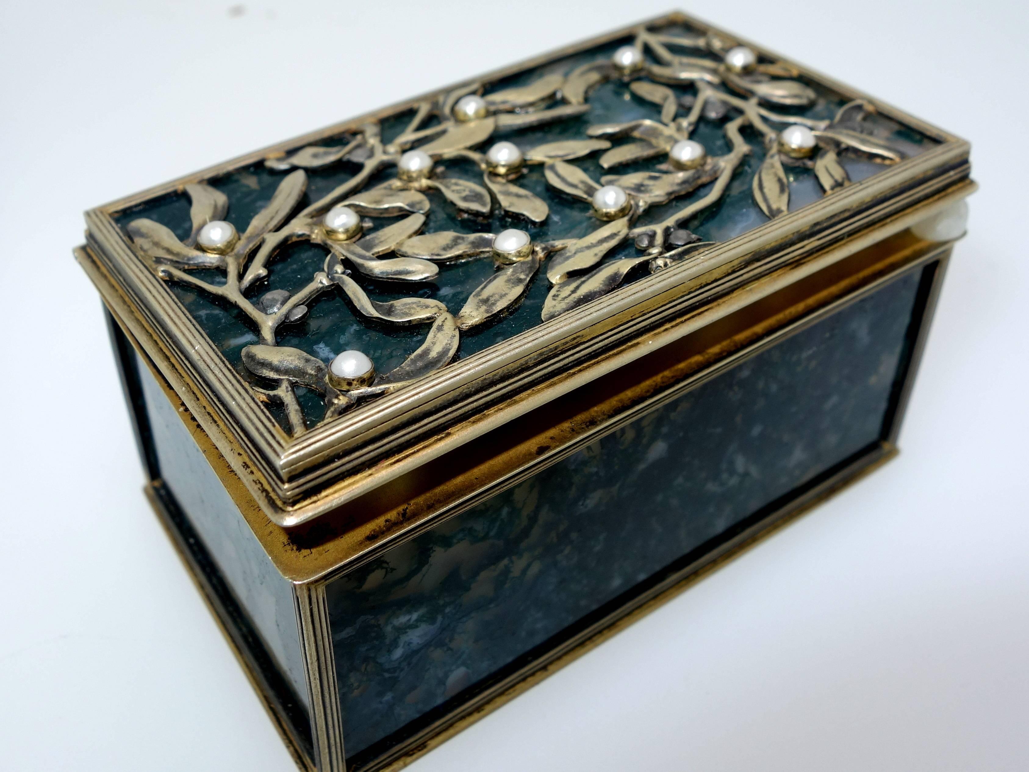 This nephrite and silver box was once owned by Russian royalty.  Please see the documentation received.  The spinach jade is decorated on the top with faux pearls in the Art Nouveau style.  This box is just shy of 3 inches long and 1.75 inches deep