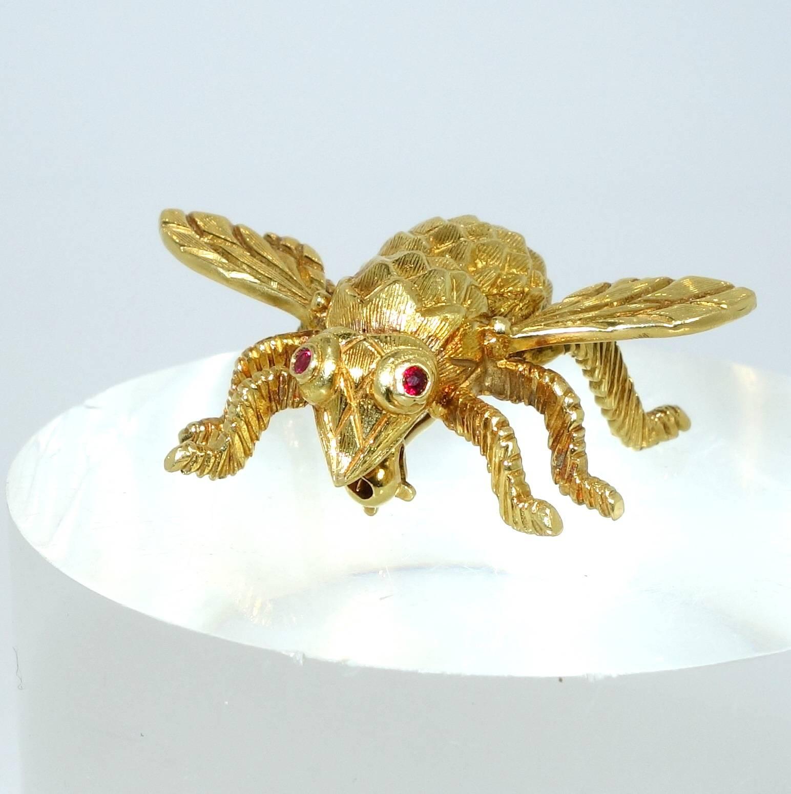 18K yellow gold with ruby eyes.  This little guy is one inch long and weighs 9.6 grams.
