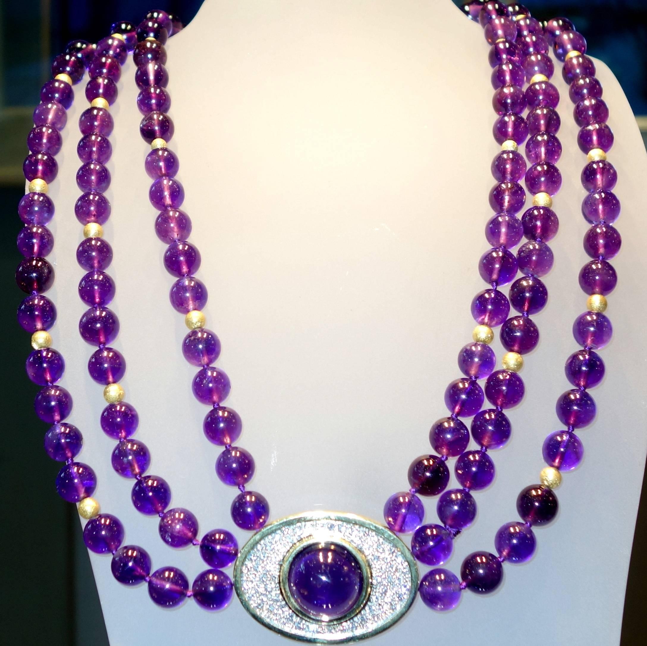 21 inches in length with over 300 cts. of fine amethyst and 3 cts. of white diamonds, (H,VS) set in platinum, this colorful necklace is also accented with gold beads.