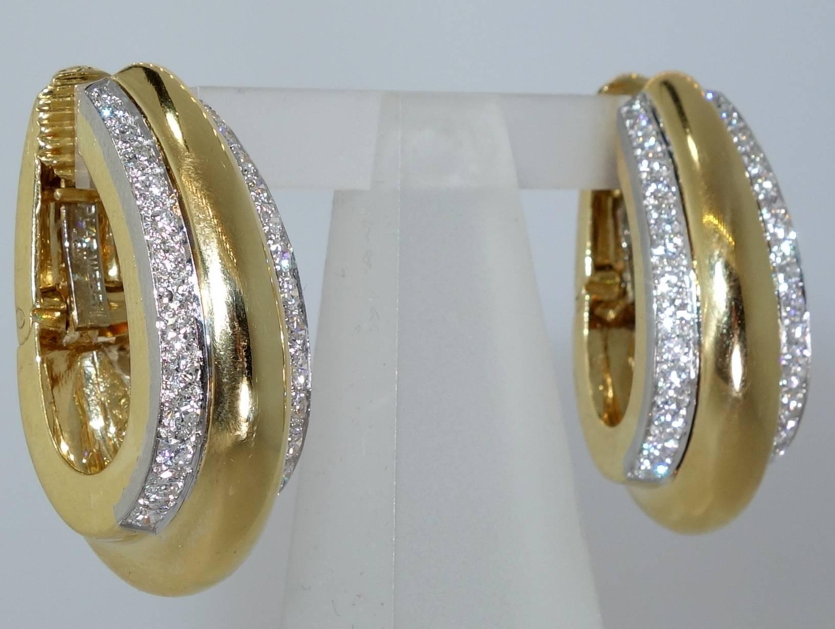56  fine white diamonds amounting to 3.6 cts of round diamonds are set in platinum in these 18K yellow gold hoop style earrings.  In fine condition, these 1.5 inches in length hoop style earrings are  signed on the verso by the world famous David