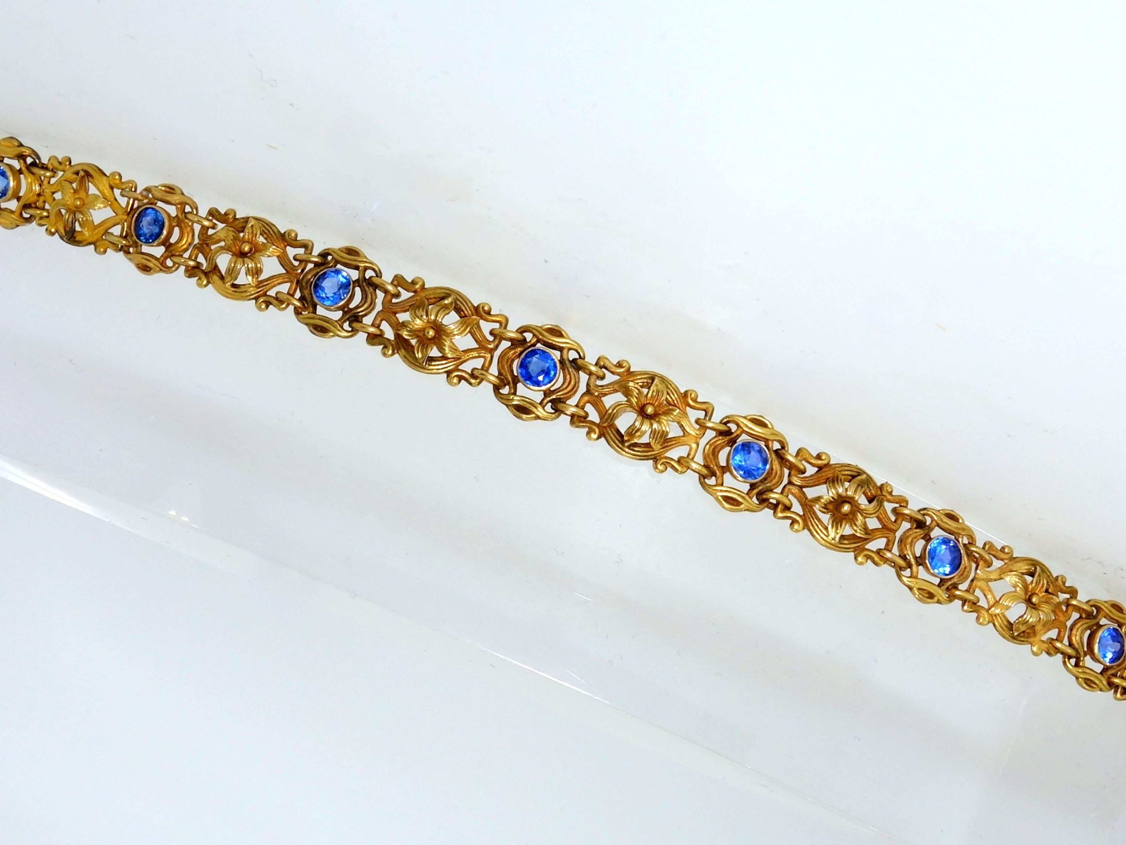 Circa 1905, this gold bracelet has seven natural bright blue sapphires (probably Ceylon), each weighing approximately .40 cts., each with a total weight of approximately 3.50 cts.  This bracelet is 7.75 inches long.  