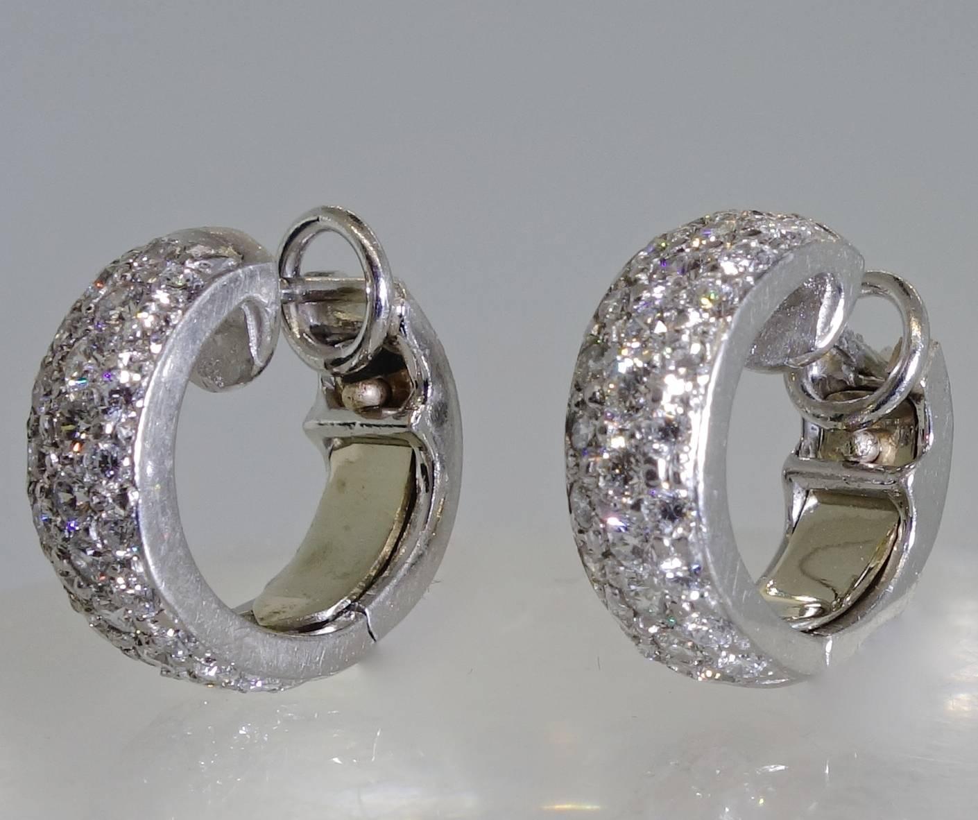 18K white gold with 56 round brilliant cut diamonds weighing approximately 1.90 cts. all finely bead set  These earrings are about .50 inches in diameter.  They are for a pierced ear now and could be alter to fit a non-pierced ear.  All of our