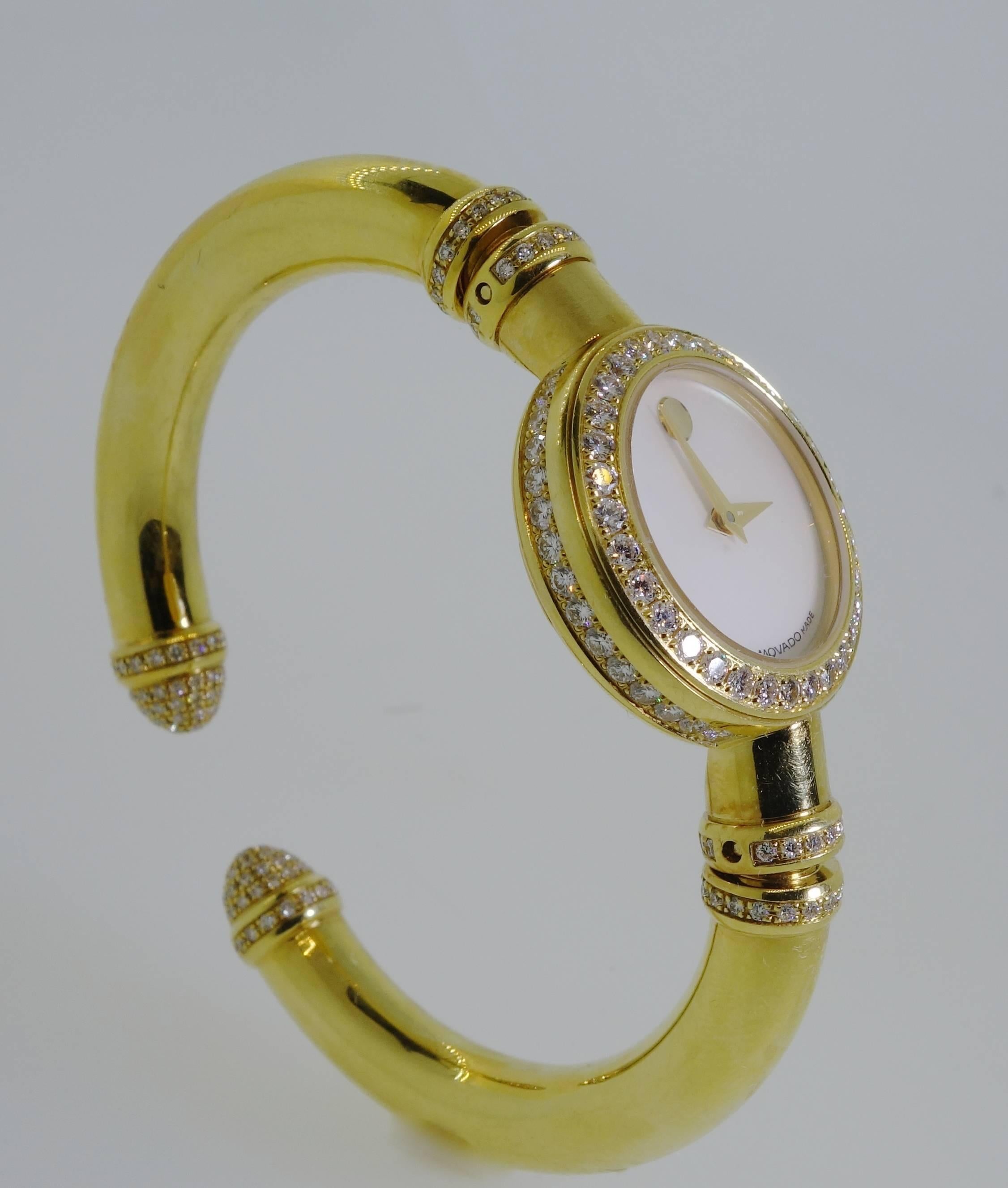 18K yellow gold bangle bracelet with 3.50 cts of diamonds - all the diamonds are well cut, near colorless (H) and very slightly included (VS).  This watch, with a mother of pearl dial, is quartz and water resistant with a sapphire crystal and by the