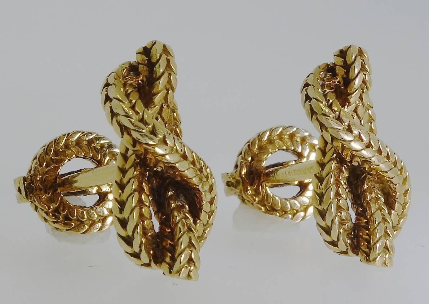 Signed and numbered and with French hallmarks, these love knot 18K cufflinks by the famous French firm of Van Cleef & Arpels weigh 24.16 grams.  Circa 1960.