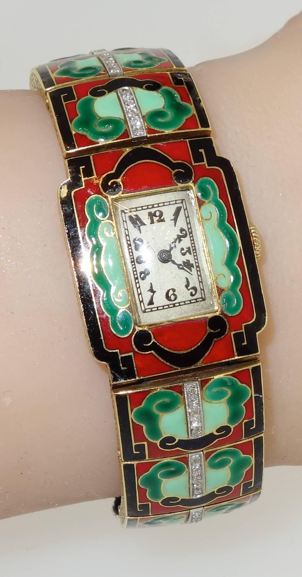 18K yellow gold with diamonds set in platinum.  This bracelet watch has three colors of enamel in an oriental "cloud" motif (under magnification one can see a very slight loss to the enamel due to wear). The clasp is original.  Original