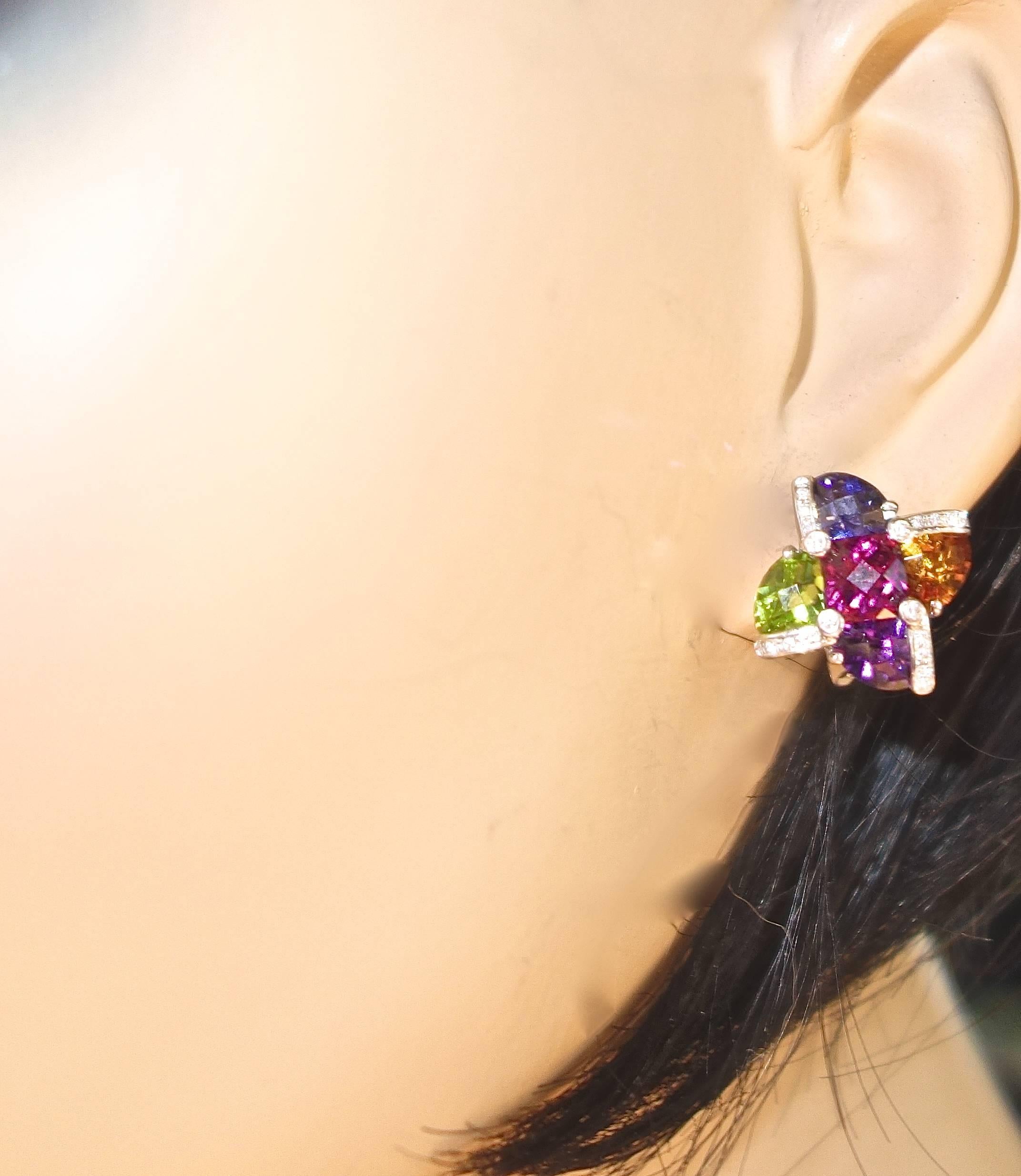 Fine white diamonds accent and decorate these multi colored gemstone earrings.  Fancy cut natural stones (Pink tourmaline, Citrine, Peridot, Amethyst and Tanzanite) with faceted tables to reflect light.  18K white gold with flip up/flip down post,