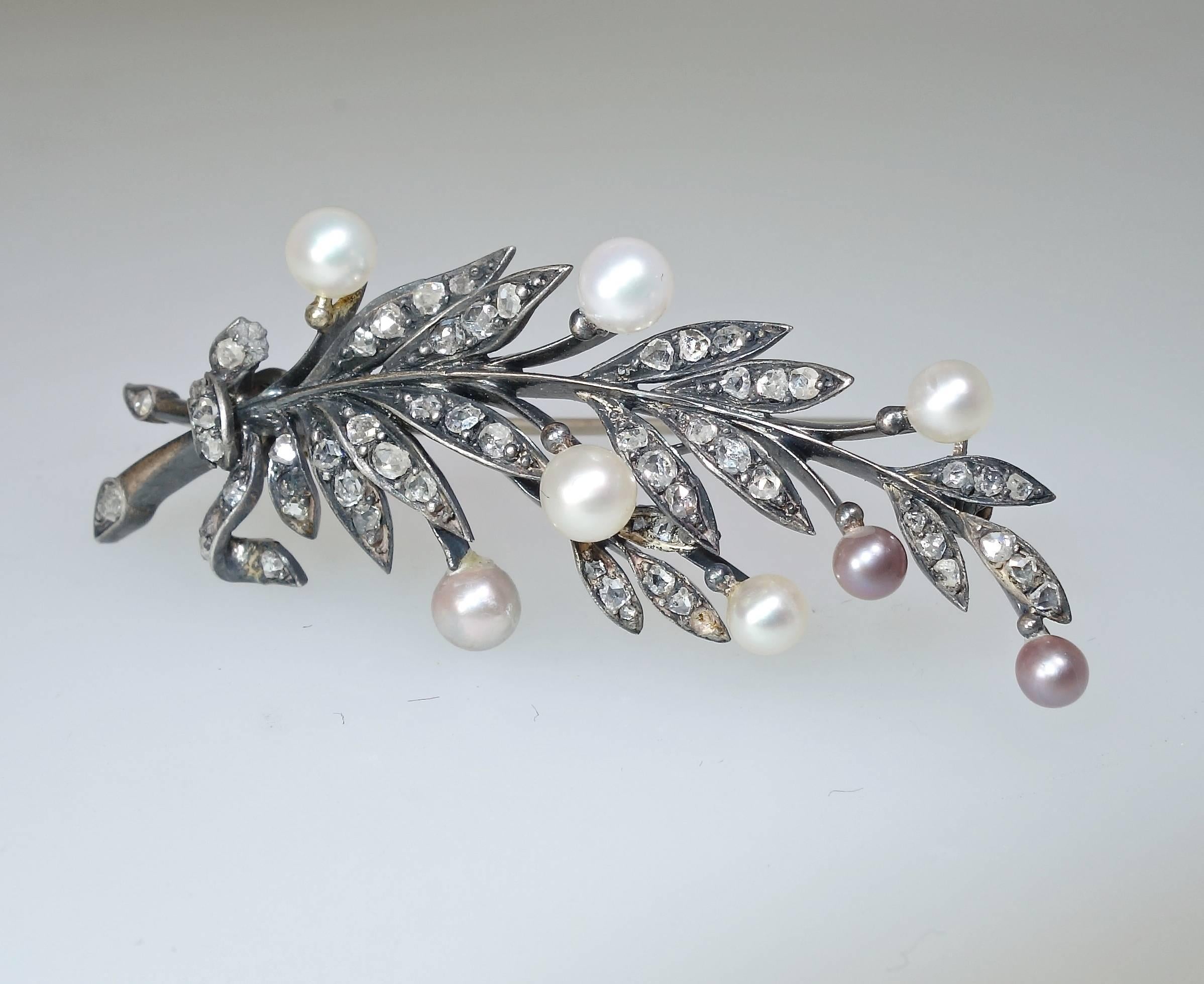 Fine natural pearls, 8, are set on posts in this very early 19th Century brooch.  The diamonds are rose cuts and bead set in silver backed with gold. The pin stem has been replaced, probably in the early 20th century.  The piece is just over 2