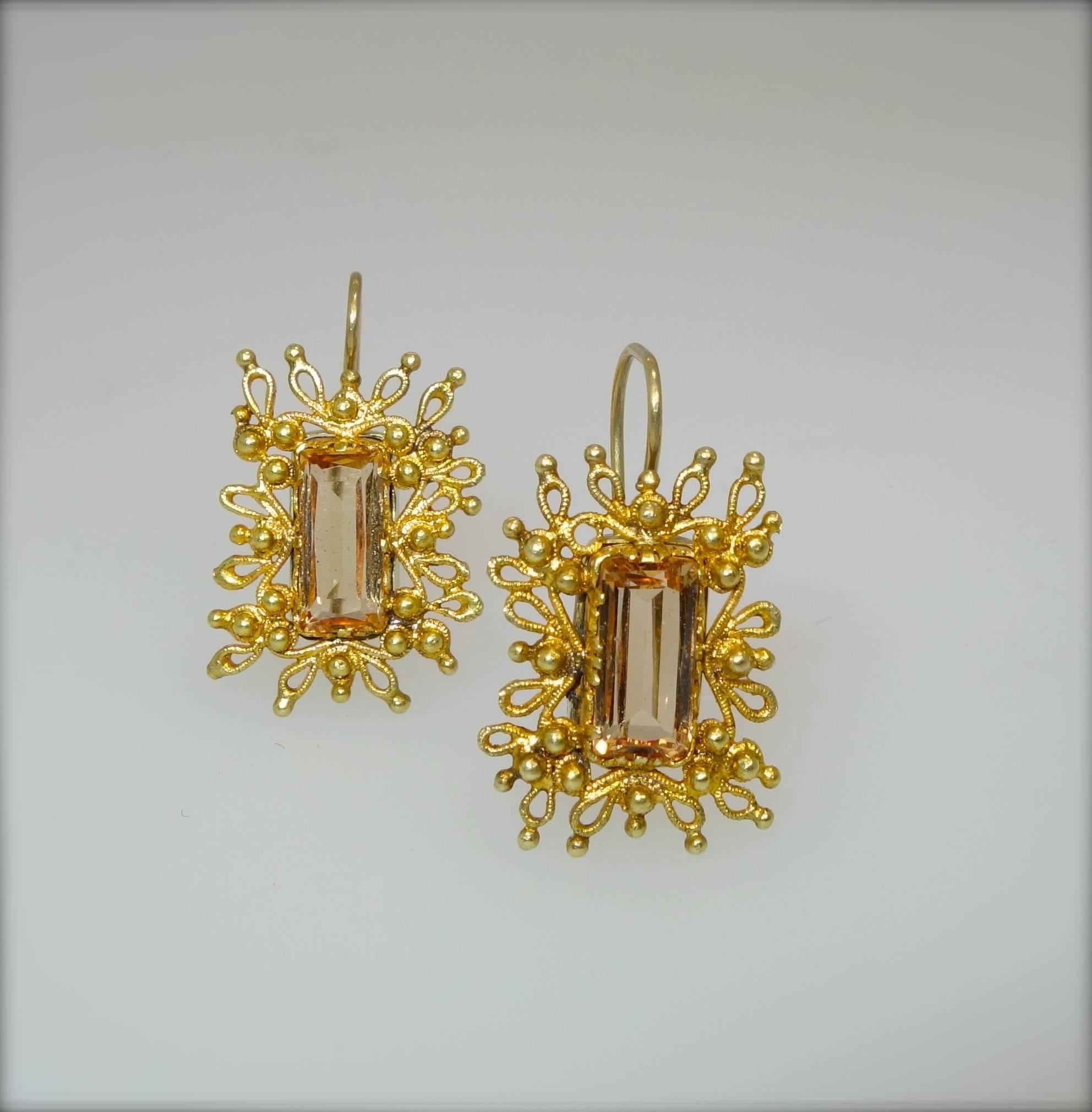 Fine cannetille gold work surround these well matched natural precious topaz stones which are accompanied by a certificate.  The earrings are .75 inches long and are in fine condition.