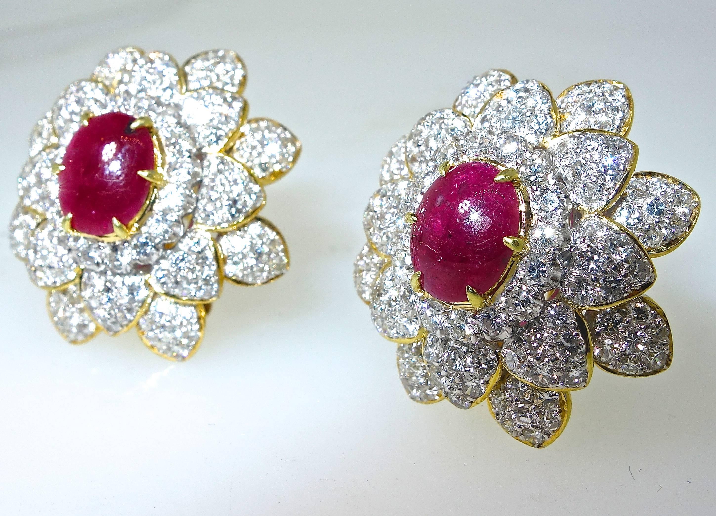 Fine bright red natural rubies weighing approximately 3 cts. totally and are surrounded by fine white modern brilliant cut diamonds (G/VS) and weighing approximately 4 cts.  These 18K earrings are well made and approximately one inch in diameter.