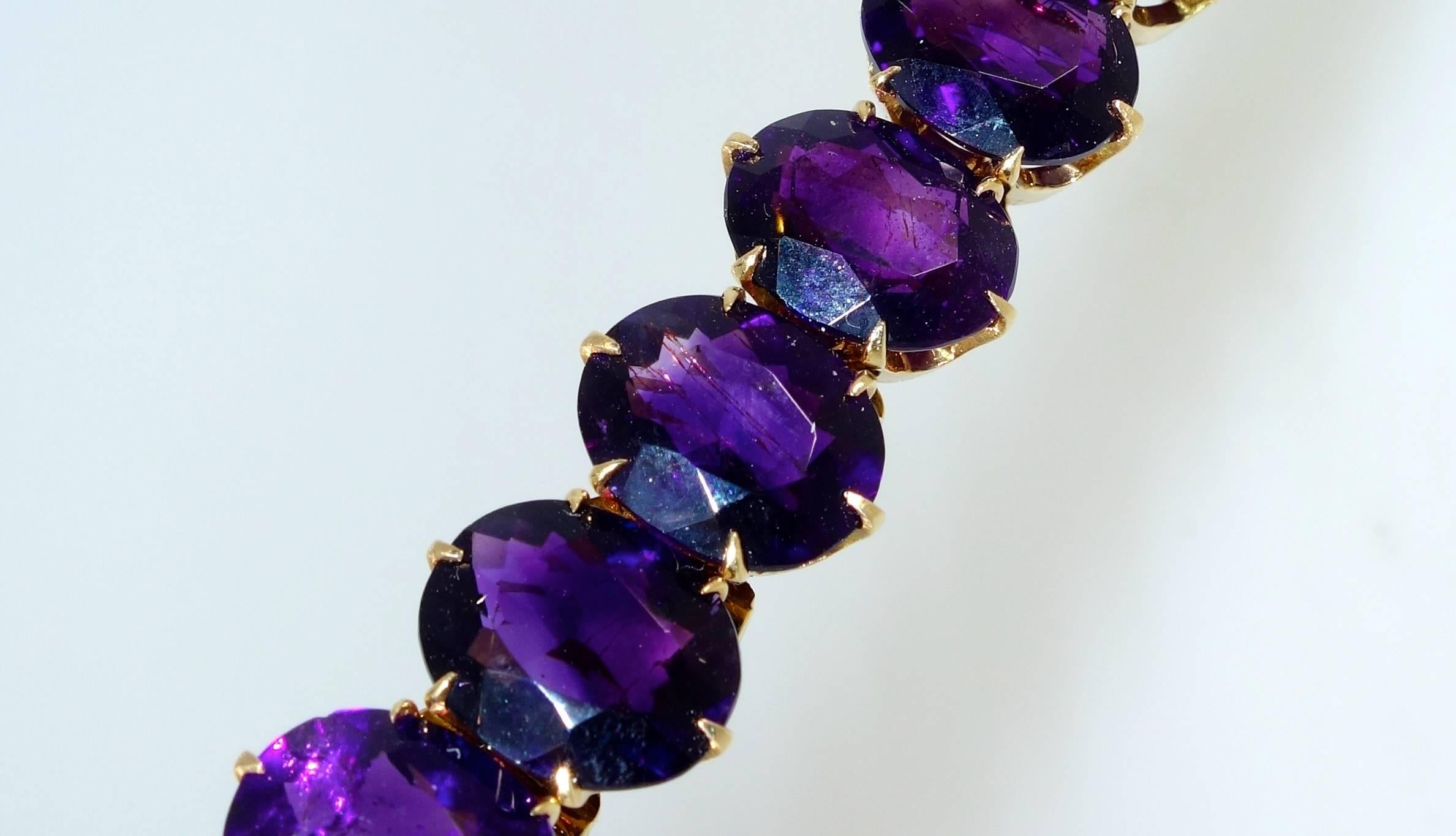 18 fine oval cut, well matched, deep color superb color Siberian amethyst bracelet.  14K gold, six inches in length, all the stones are hinged on the verso.

