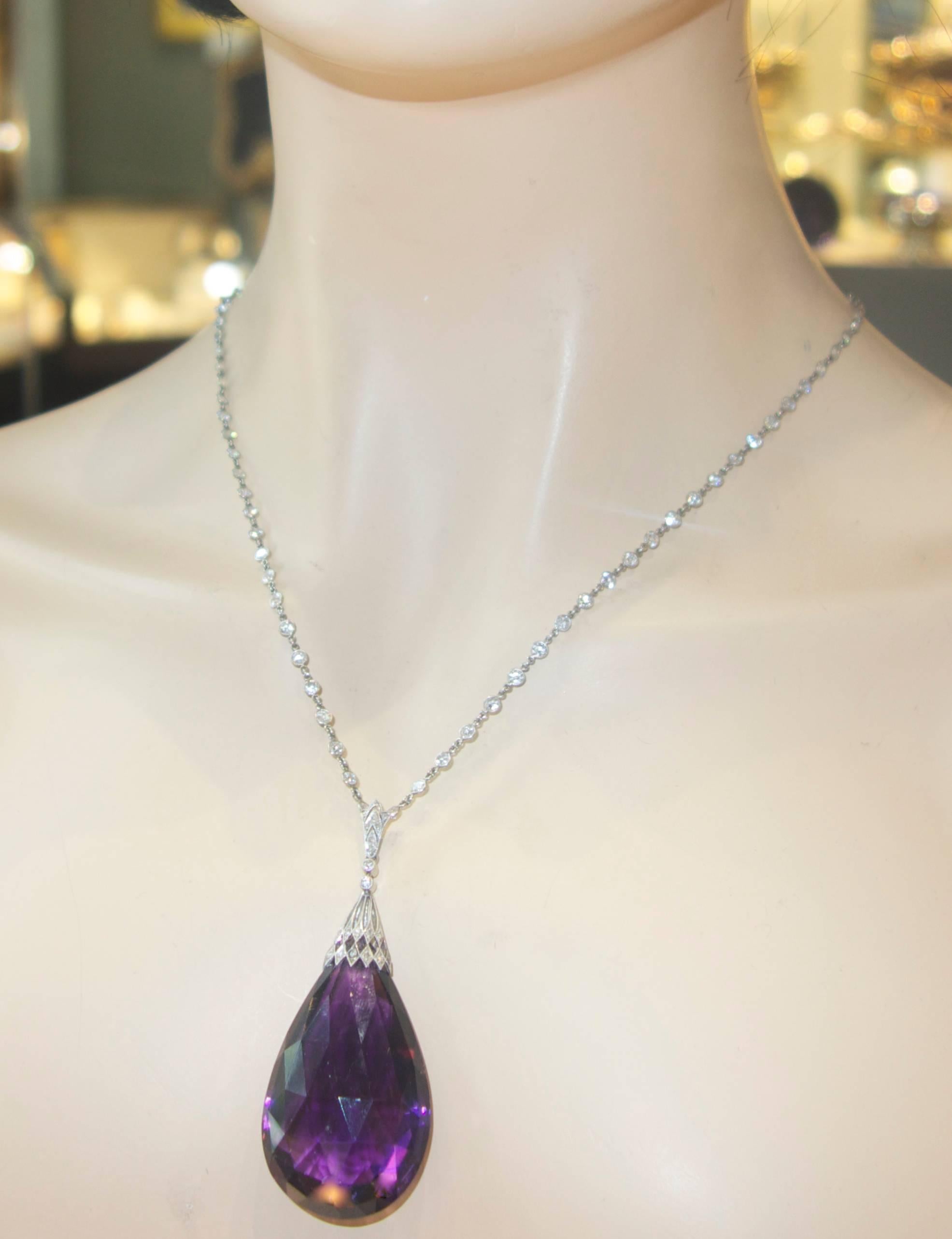 Platinum and rose cut diamond pendant suspending a fine deep purple facetted briolette amethyst weighing 114 cts., this pendant is Edwardian, circa 1910.  The 16.5 inch platinum and diamond chain is contemporary and has approximately 5 cts.  