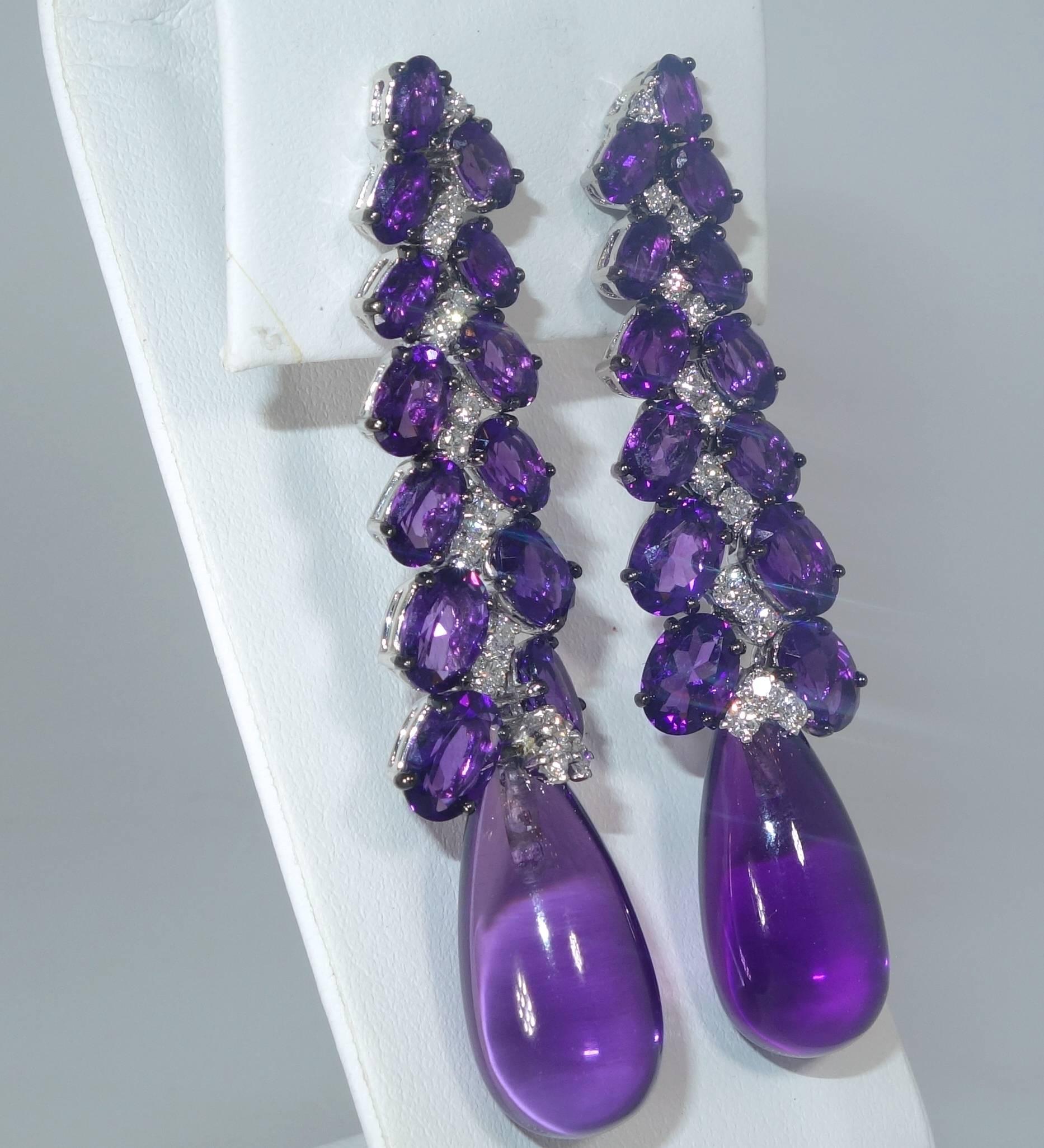 Unusual design which is very colorful possesses approximately 40 cts. of fine amethyst which is accented with .70 cts. of brilliant cut white diamonds, color is H (near colorless), and VS (very slightly included) approximately.  These 18K white gold