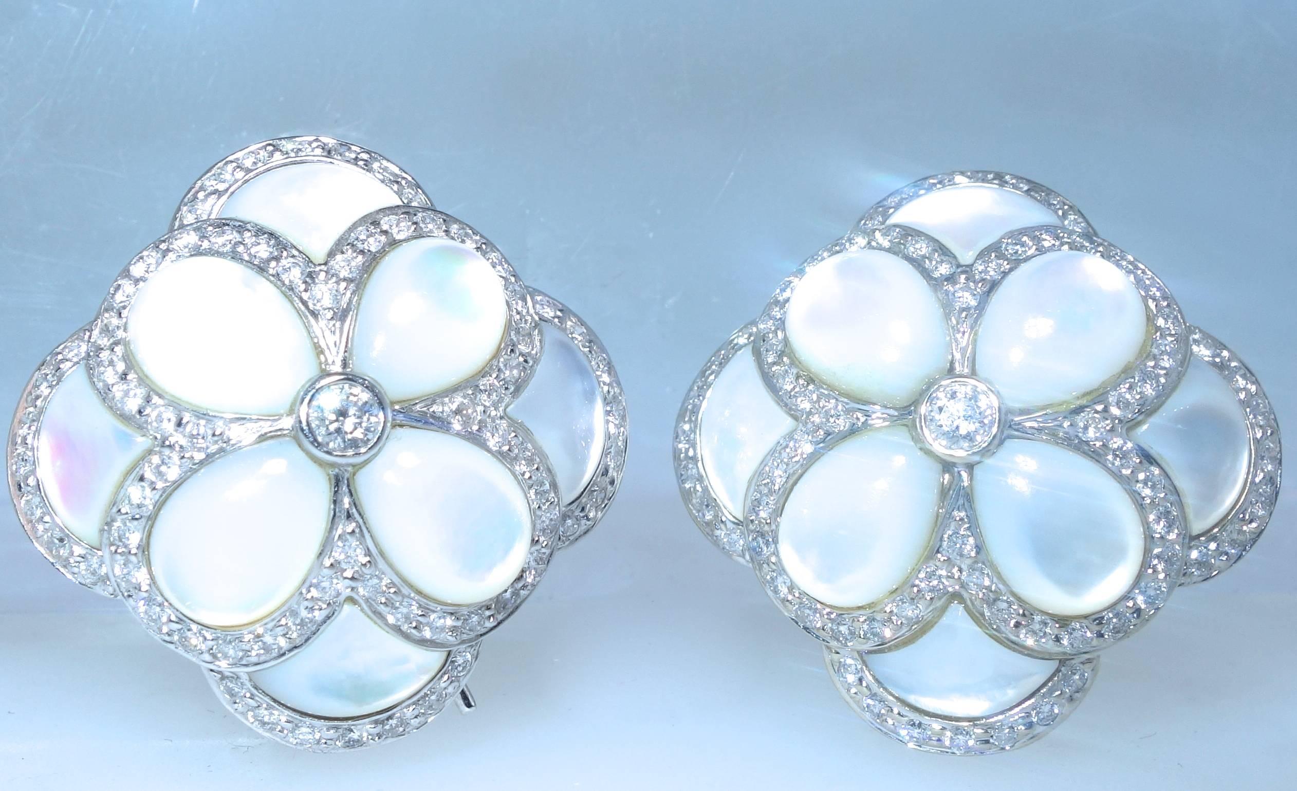 350 well cut, near colorless and very slightly included brilliant cut diamonds totaling approximately 3.50 cts.  The mother of pearl (displaying a slight pink/light blue hue) stones are all fancy cut creating a lovely flower motif. Slightly  domed