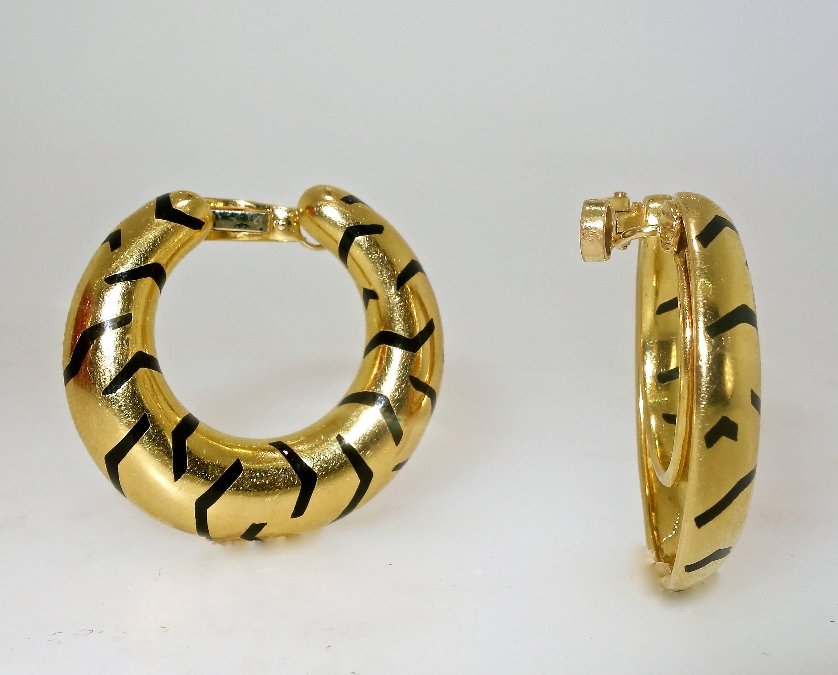 From their "Big Cat" jewelry, these Cartier black enamel striped hoops are 18K.  They are signed, numbered and possess French hallmarks.  They are 1.25 inches in diameter.  They can be for a pierced as well as a non pierced ear.