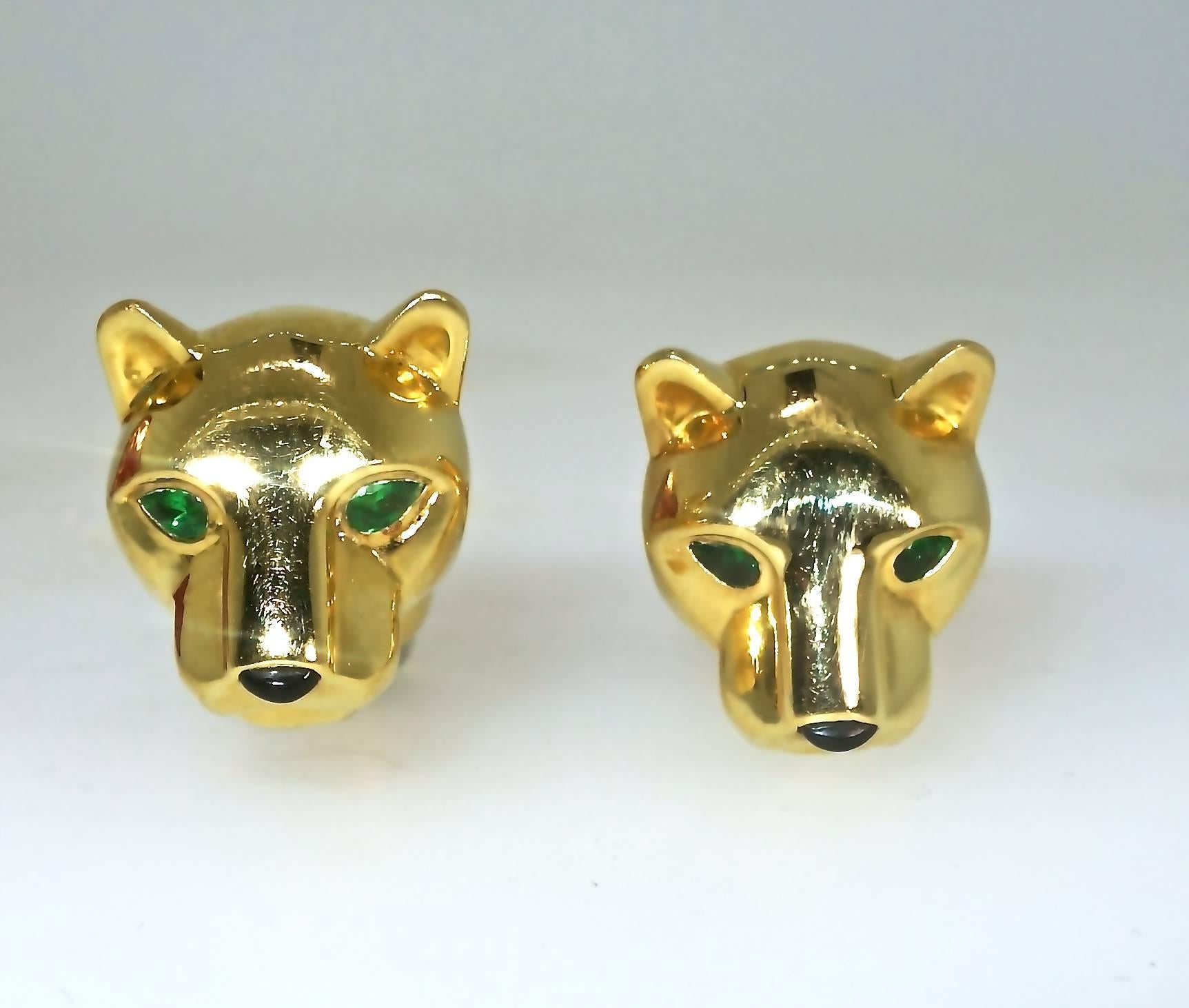 18K yellow gold with emerald eyes and black enamel on his nose and on the bar bell back, these cufflinks are signed, numbered and with French hallmarks