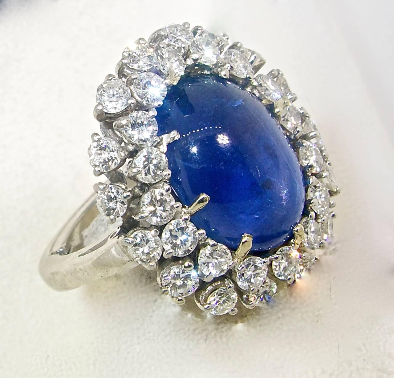 AGL has certified that this 14.27 ct fine blue natural Ceylon sapphire has not been subjected to heat and is thus entirely natural.   The sapphire is a pure bright blue with a  6 pointed star in the center..  This center stone is surrounded  by fine