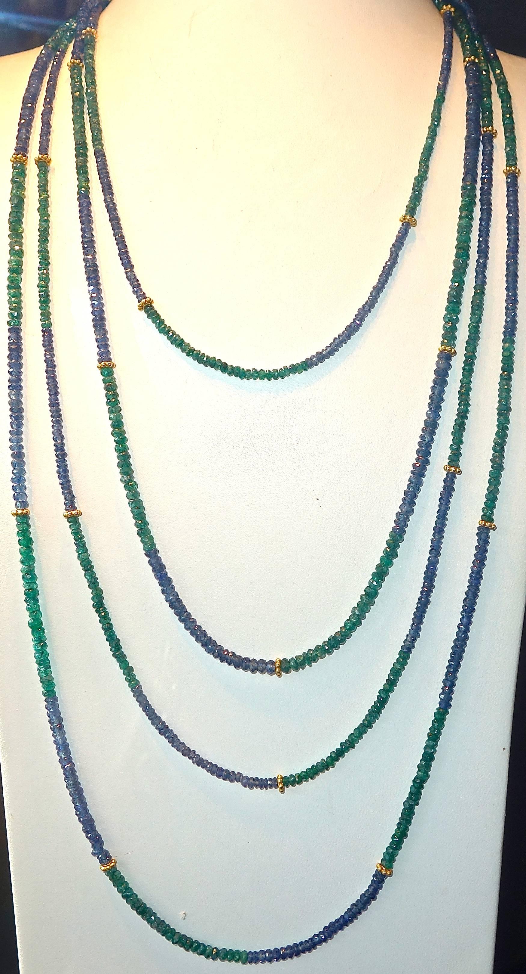 Fine bright facetted sapphire and emerald beads are interspersed with floral motif 18K roundels. This necklace is 108 inches long and thus can be worn several different ways double over and tripled and quadrupled.  The 27 18K gold roundels create a