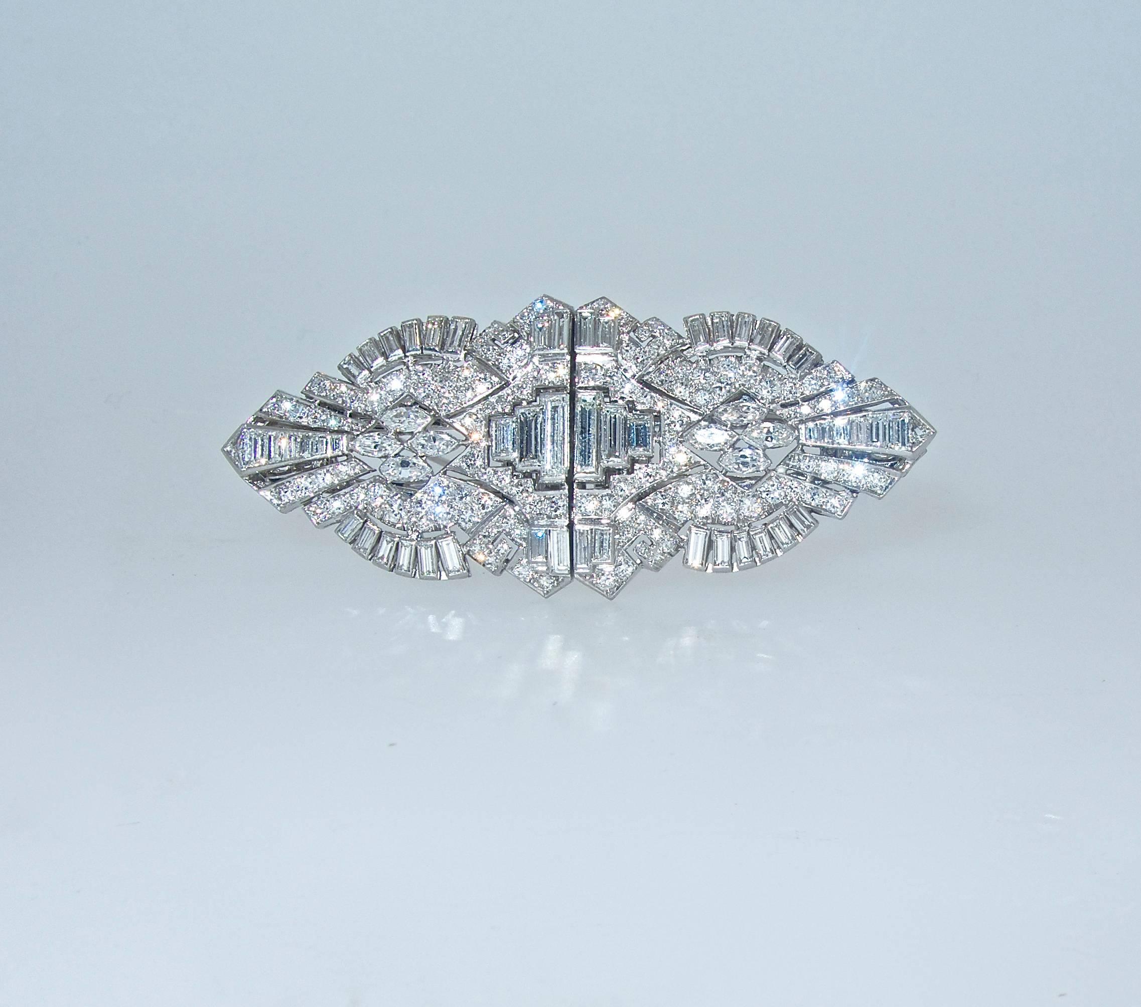 This platinum period piece can be worn as two clips or it fits together with a 3rd element stabilizing it as one brooch.  It is 2.5 inches in length and just over 1 inch high.  There are approximately 4.7 cts. of fine diamonds - marquis cut,