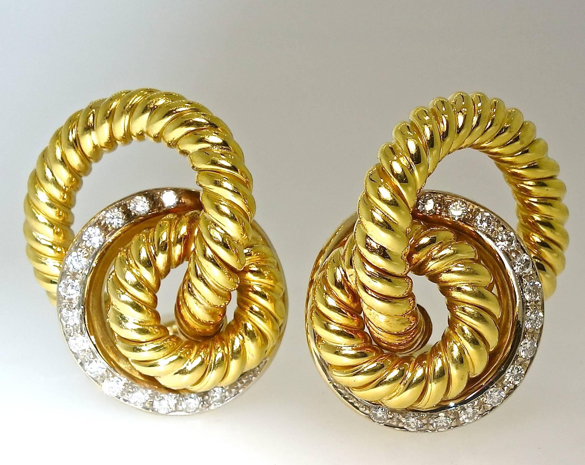 Gold twist design accented with 28 fine white diamonds - all well matched, near colorless and very slightly included (H/VS), these modern brilliant cut stones are set in white gold.  There are 1.0 cts. of diamonds.  These earrings are 2.25 inches