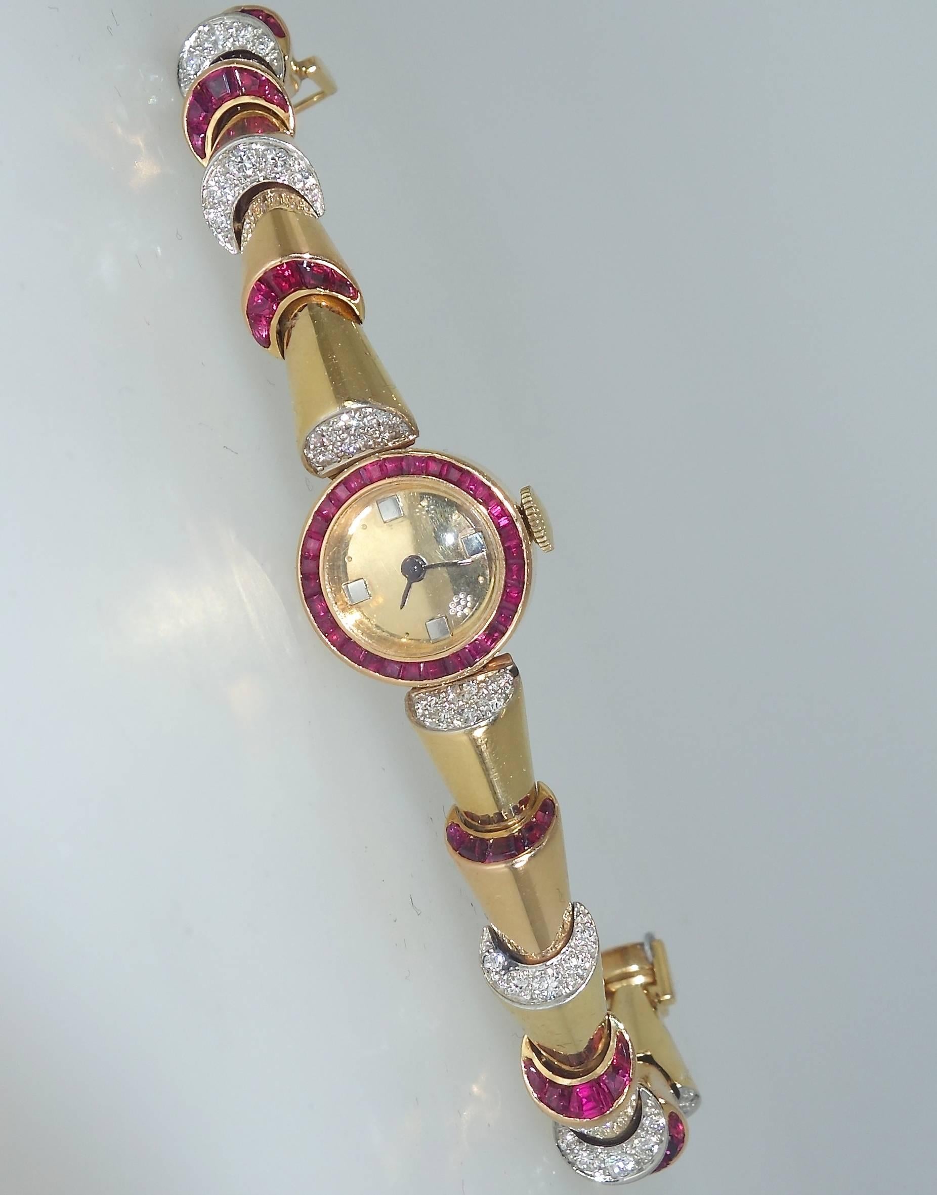 This unusual design - referred to as an "escalator" motif" of alternating fine fancy cut natural rubies and round white brilliant cut diamonds.  The watch which has recently been serviced is signed and numbered by Oscar Heyman &