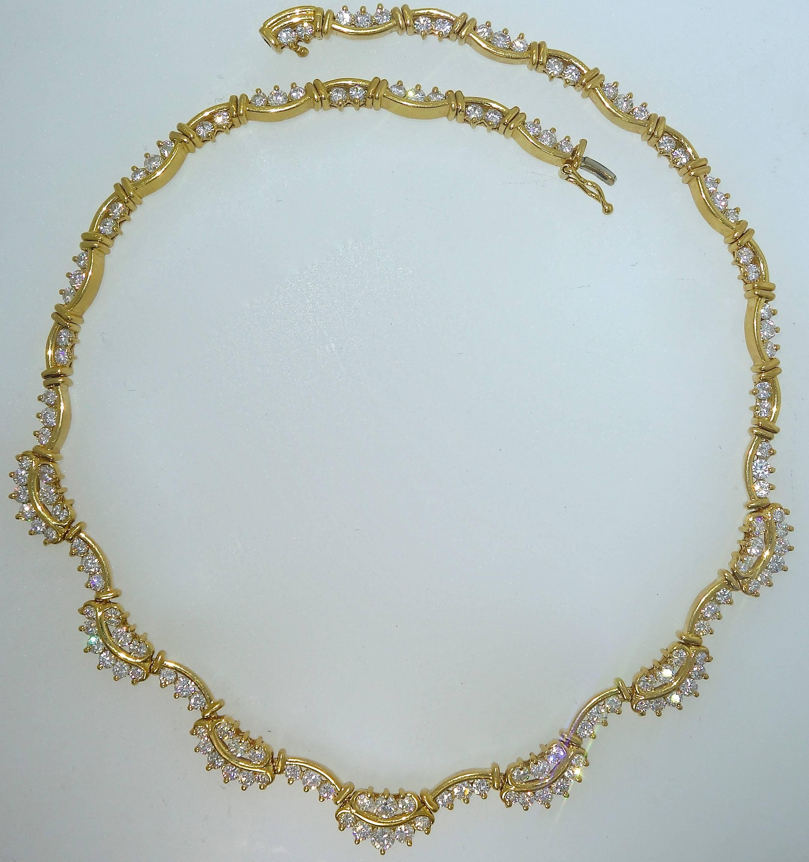 18K yellow gold necklace with 138 fine white diamonds - all near colorless and very slightly included (H,VS).  There is a total of 9.2 cts.  This necklace weighs 51.15 grams, it is 14.75 inches long and 1.8 inch wide.  The delicate scroll pattern