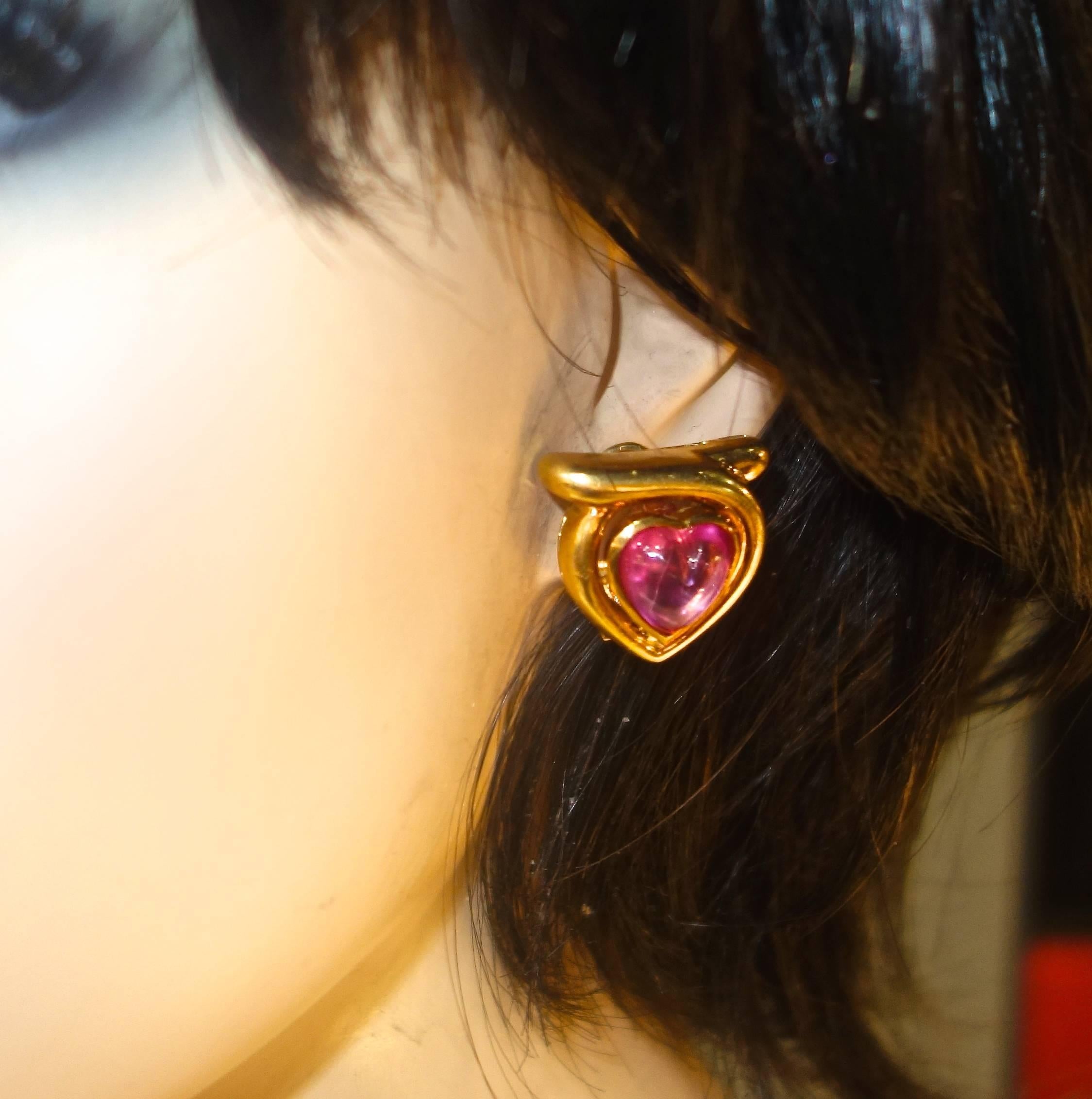 The heart shaped natural pink sapphires are a bright deep 