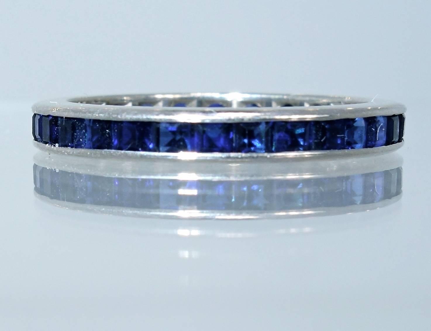 Thirty natural vivid blue, square cut, sapphires weighing a total of approximately 1.0 cts. channel set in 14K white gold.  This eternity band is a size 6.