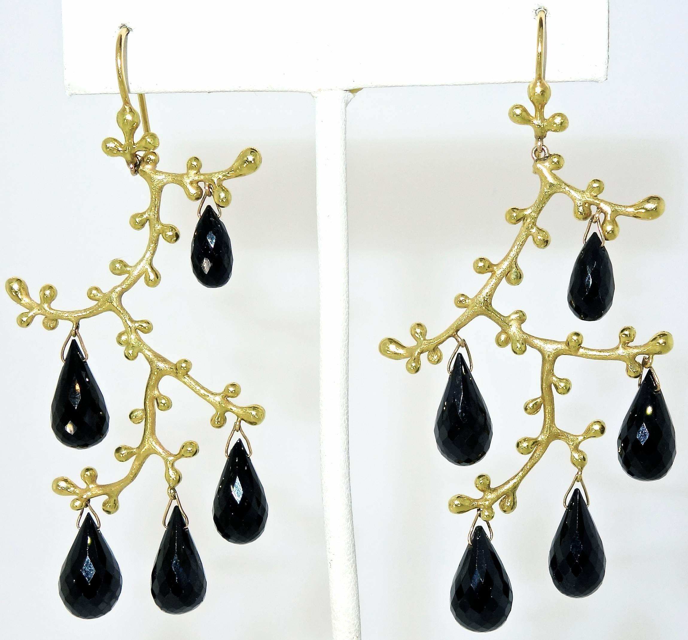 18K yellow gold hanging earrings with 10 faceted briolette cut onyx weighing approximately 10 cts. These earrings are three inches in length and weigh 22.7 grams.