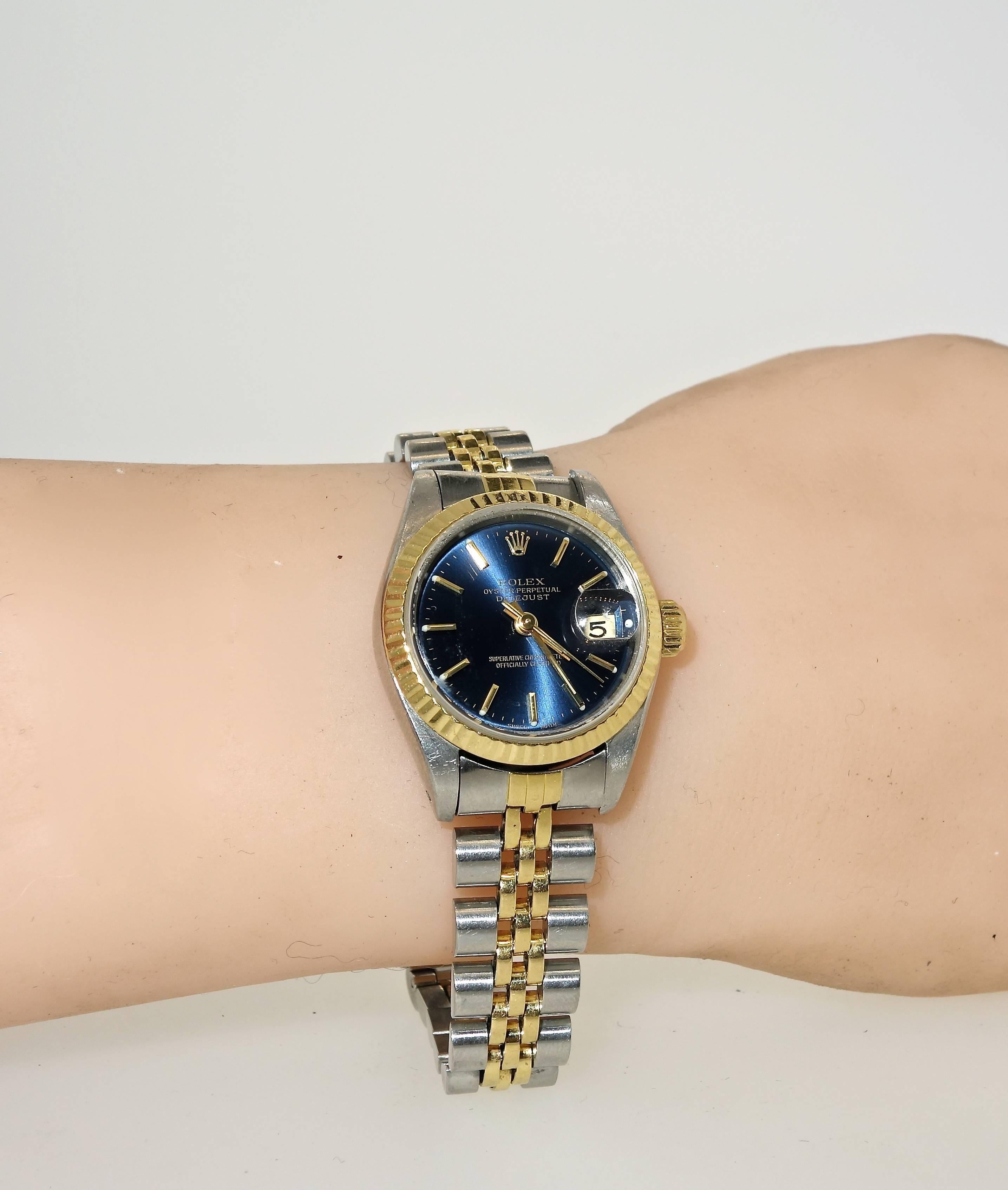 Ladies Rolex with dark slate blue dial, two tone - stainless and 18K yellow gold.  18K fluted bezel,  quick set, sapphire crystal, jubliee Rolex bracelet, Rolex deployant clasp.  27 mm. case.  Model 69173, serial number E478541.  Year: 1990. 