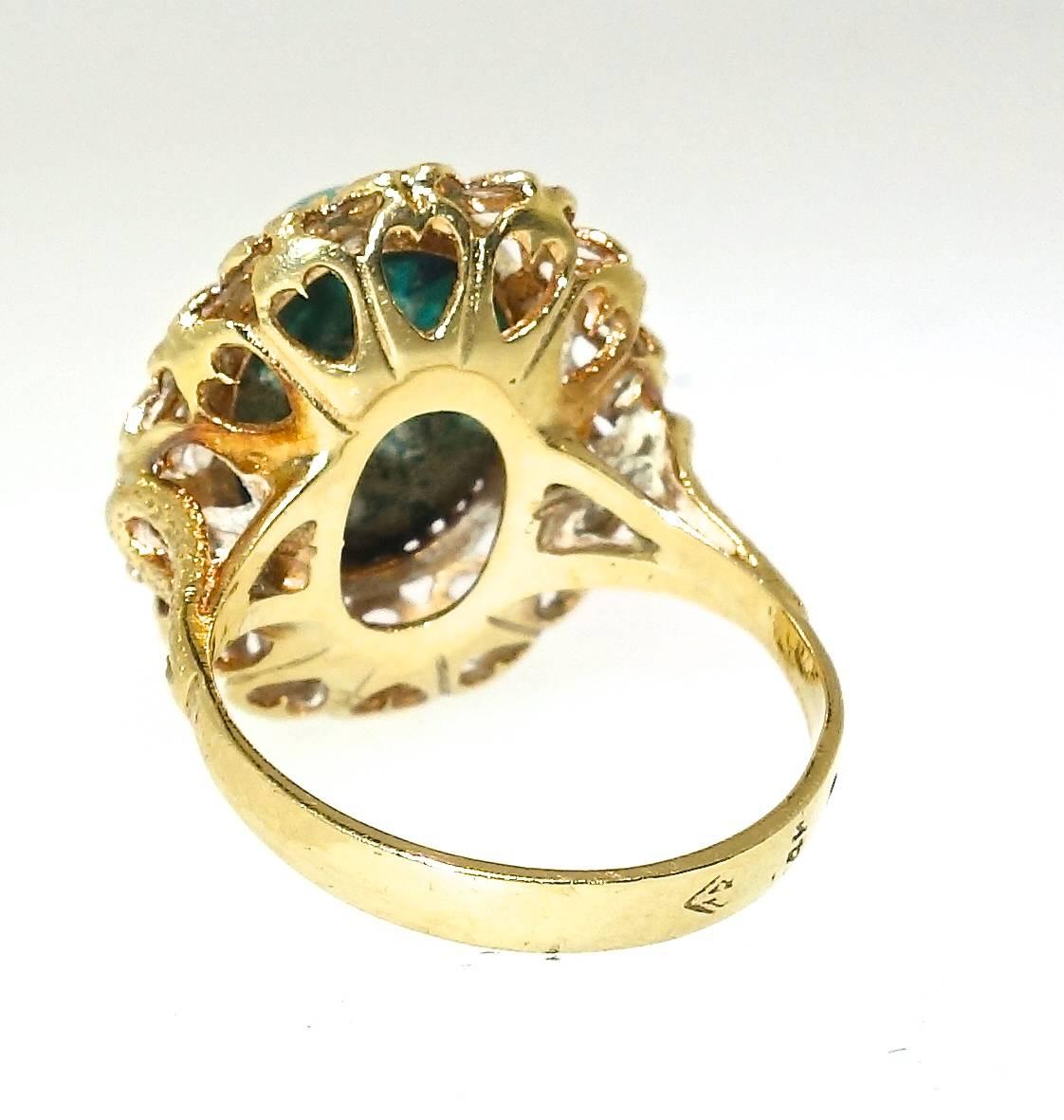 Natural Malachite, weighing approximately 5 cts., set in an ornate gold ring.  This ring weighs 5.35 grams and is now a size 6 and we can easily size it.  Note, the fine tracery work in the gallery!