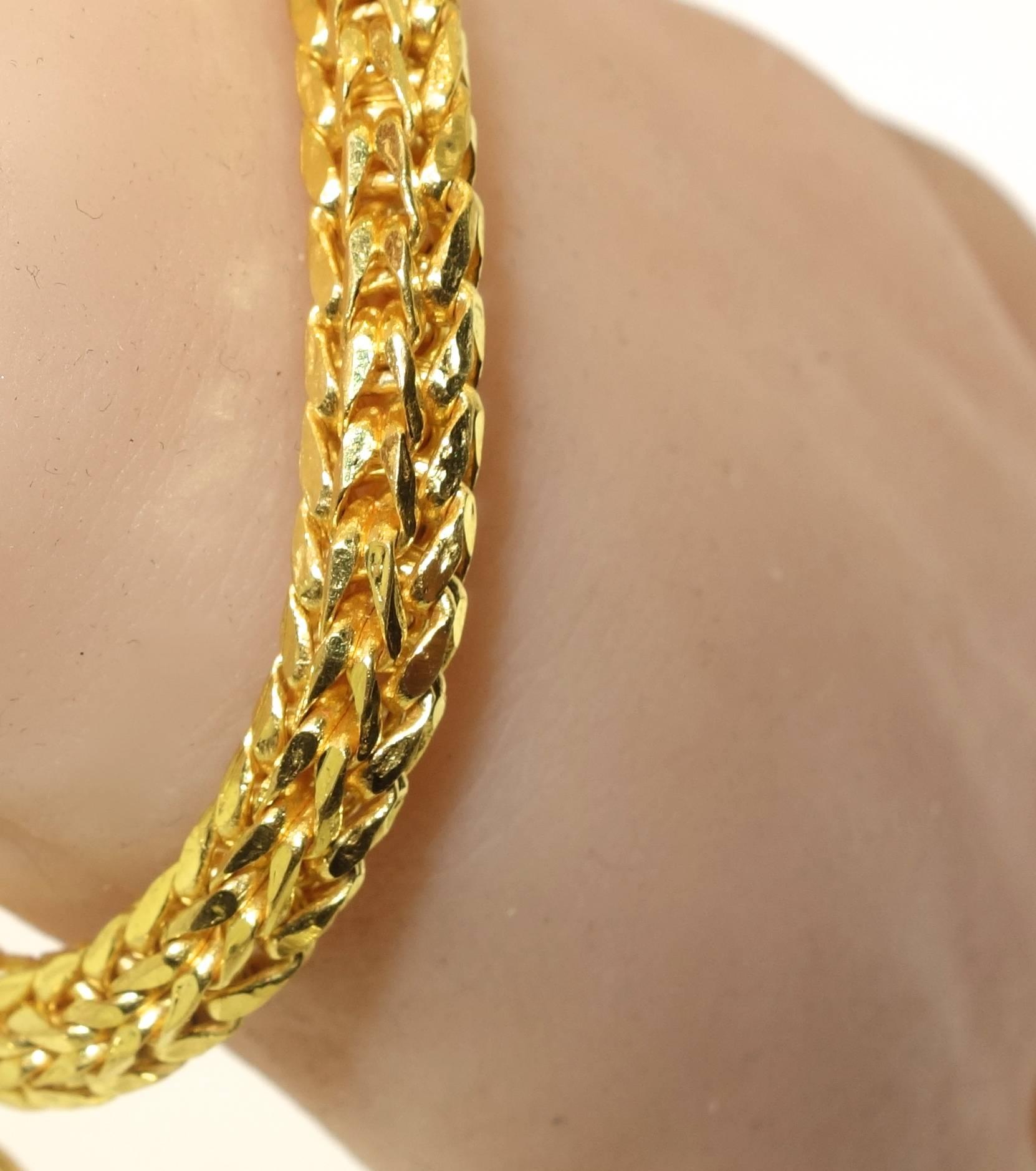 96.5% pure gold (marked as such on the inside), the bracelet is 7 inches long of finely braided gold terminating with a lovely heart shaped charm.  30.34 grams.  This bracelet has a gold scrap value of over $1200.