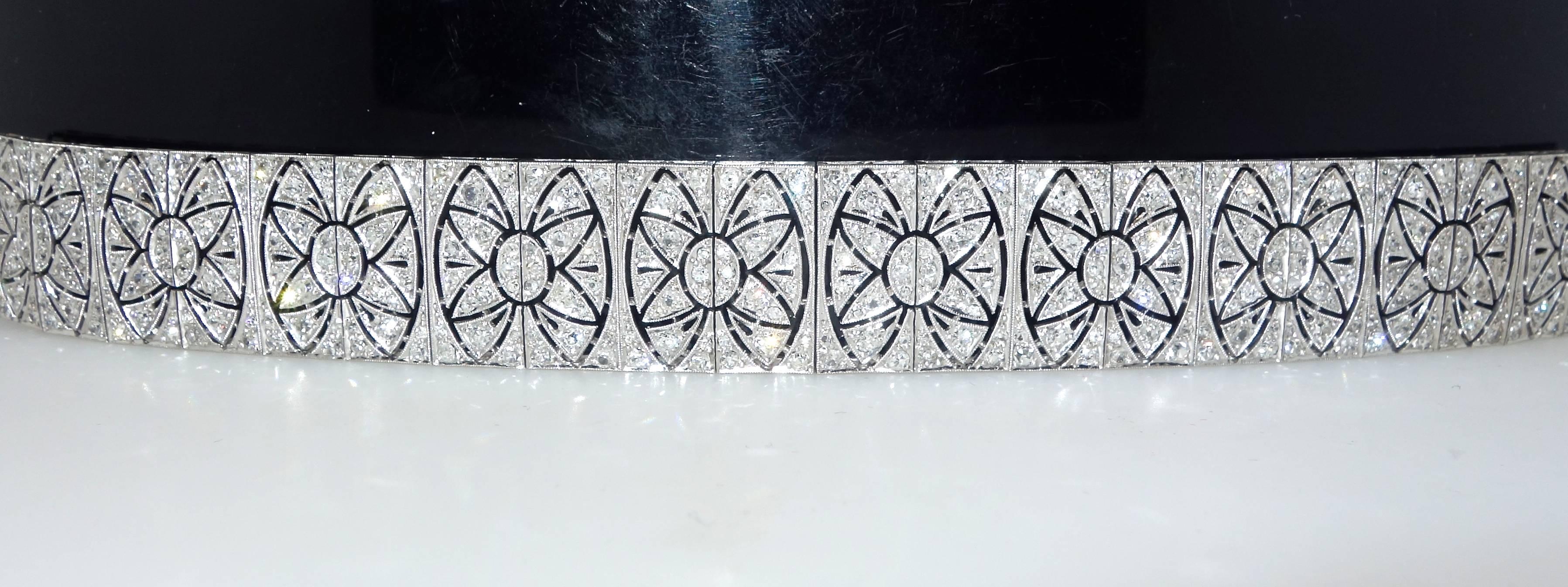 Platinum and diamond bracelet set with 346  old cut diamonds creating a starburst or snowflake repeating design.  This wide band bracelet has collectively 5.6 cts. of diamonds.  The diamonds are all near colorless and very slightly included,