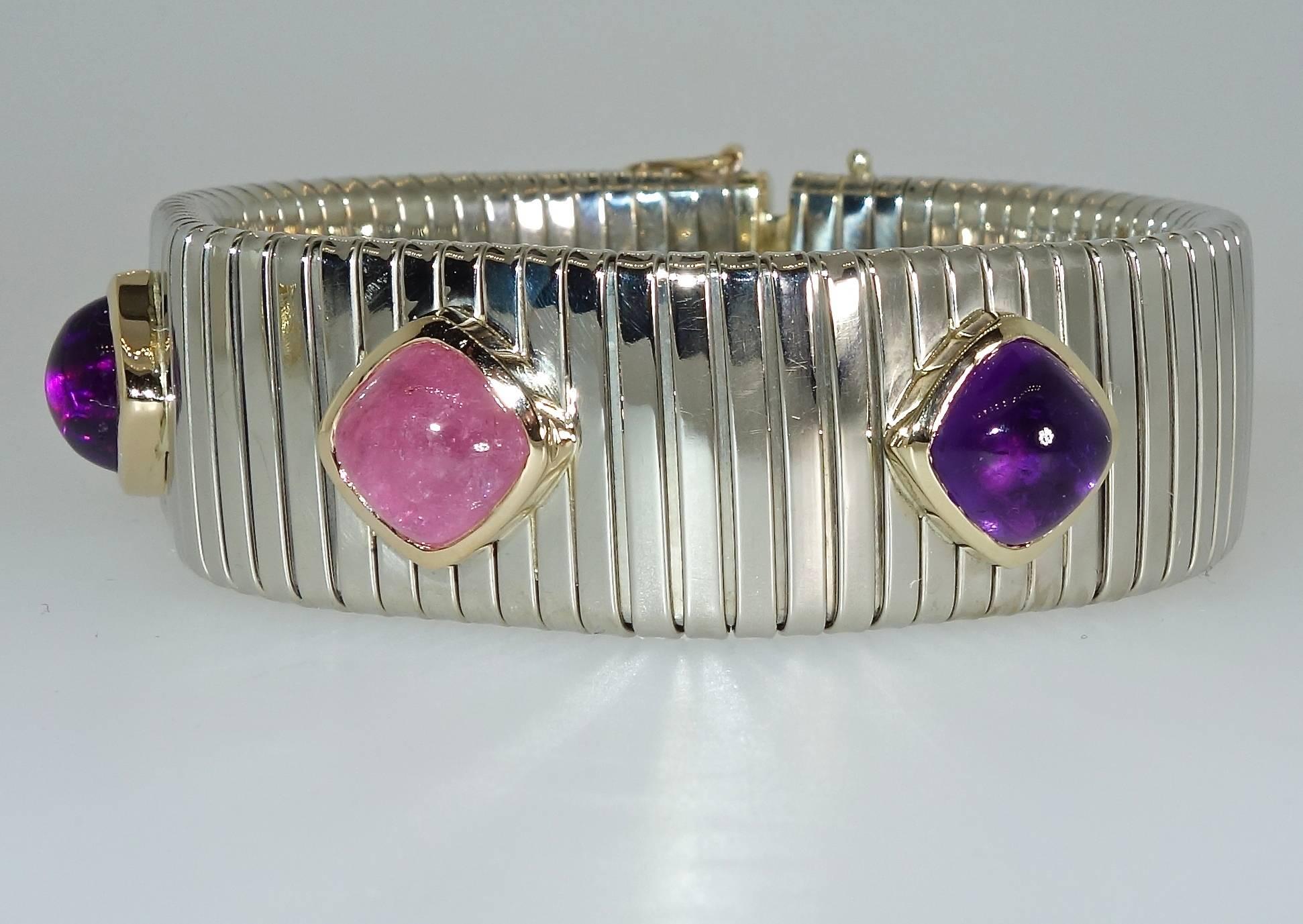 The bright stones all are a sugar loaf high cabochon set in bezels of gold  then set in this slightly expandable bracelet with a fine invisible clasp.  The stones weigh approximately three carats each.  This modern design piece is seven inches long