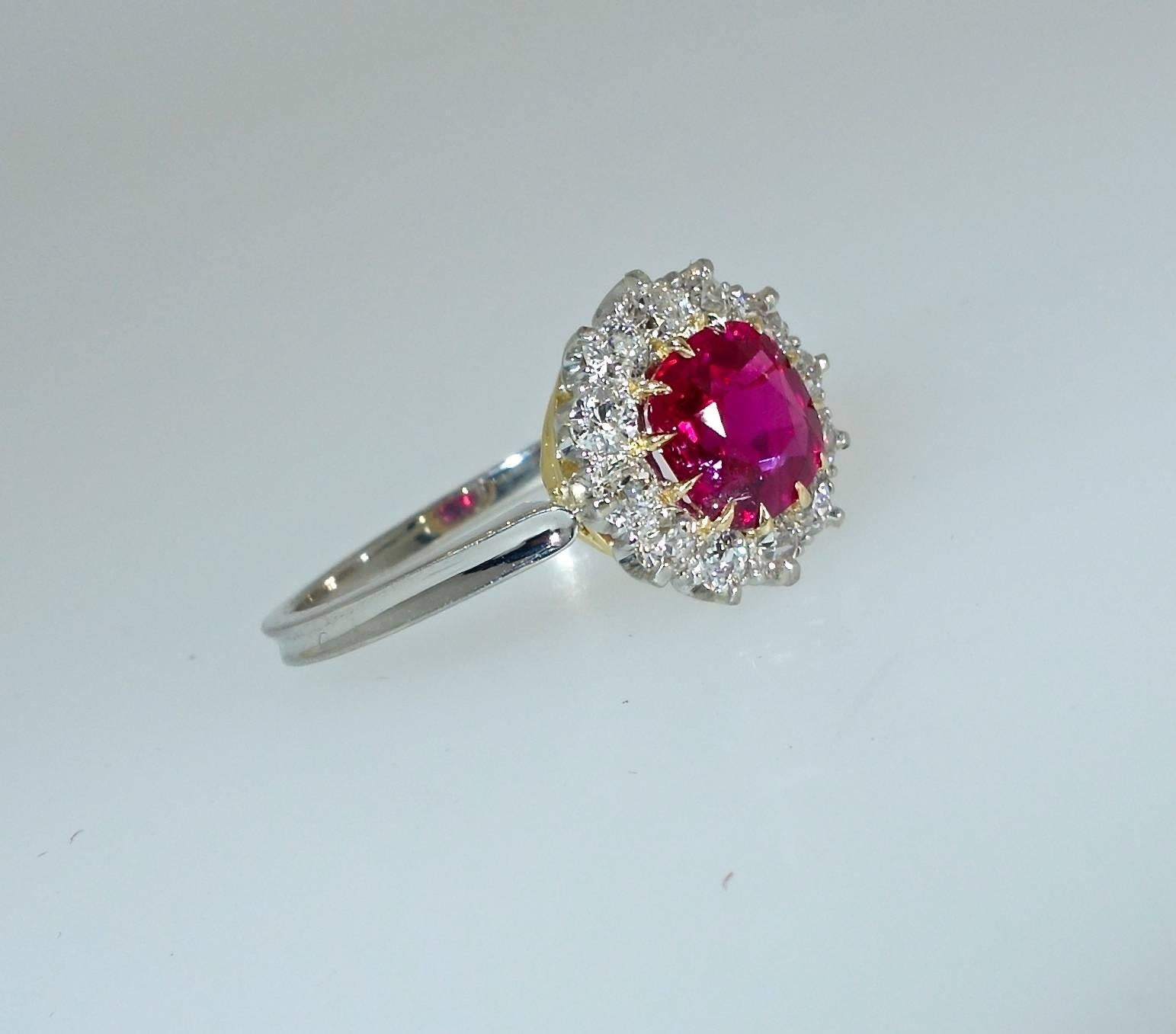 The center ruby weighs 1.3 cts. and displays the an exceptional color red which has made such stones from Burma extremely sought after. This bright ruby, which is very clean, held by 12 yellow gold prongs, is cut is an early mine cut - a cut usually