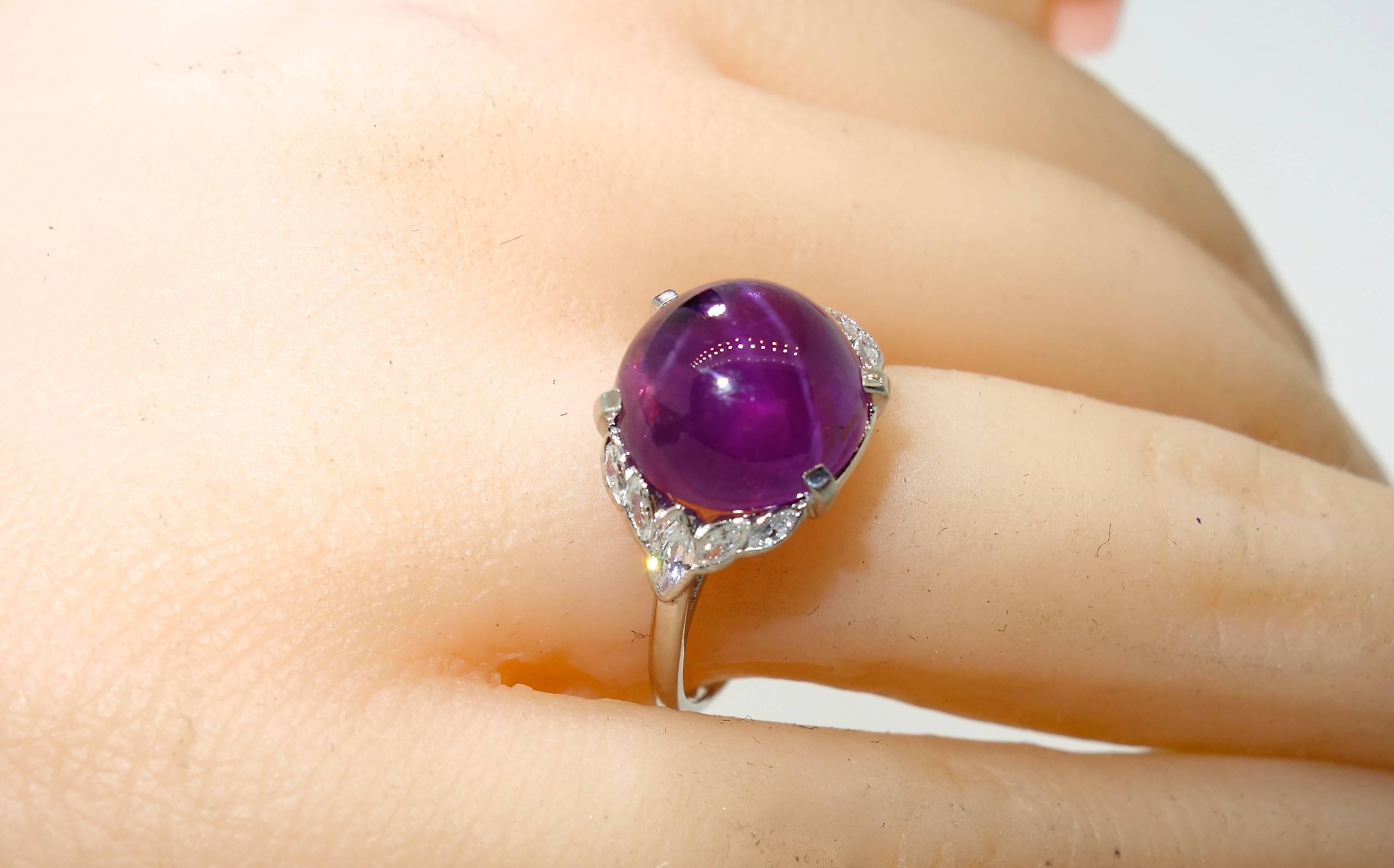 The fine center stone is an unusual natural star sapphire weighing 6.6 cts. in a delicate early 20th century platinum and diamond ring by the famous jewelry house Birks.  There are 10 marquis cut diamonds all near colorless (G/H) and very slightly