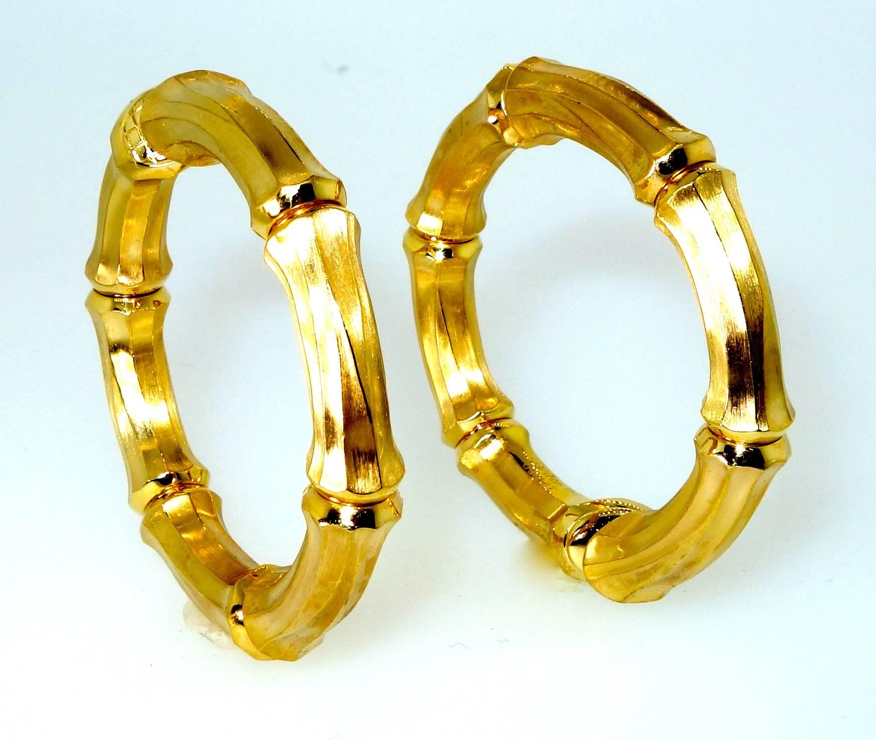 The largest size of this popular bamboo motif hoops by Cartier.  Signed and numbered with the marks for 18K, these hoops are two inches in diameter and the width varies from 1/4th to 5/8 inches and weigh 38.8 grams. These earrings are now for a non