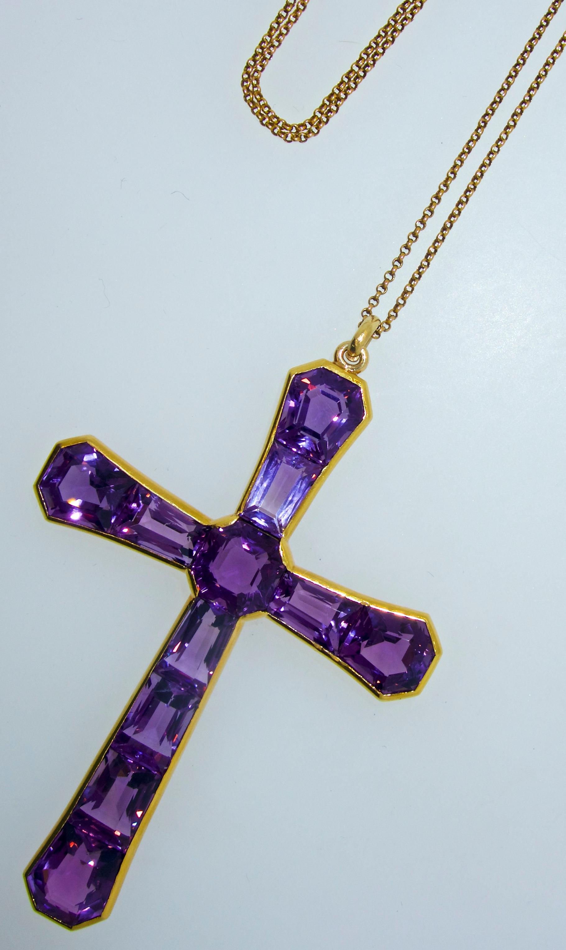 Antique Victorian cross made up of fine fancy cut deep purple amethysts weighing approximately 50 cts., this cross is suspended on an 18K chain, and is 3.5 inches in length.  The amethysts are quite fine all displaying a fine medium to deep bright