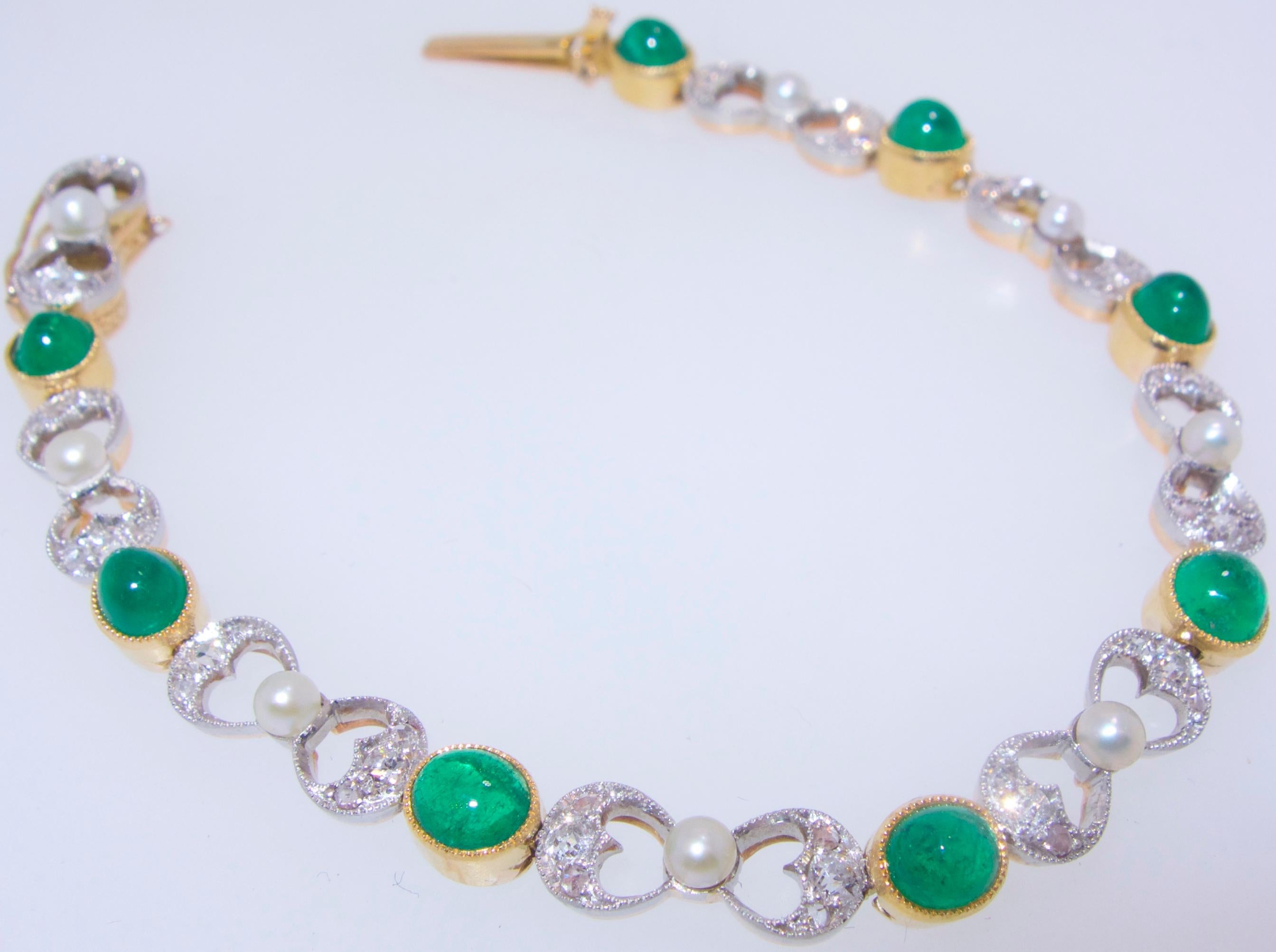 Antique, turn of the century, emerald, diamond and natural pearl platinum topped 18K gold bracelet.  This bracelet has 8 natural pearls, 8 Colombian Emeralds, weighing approximately 6 cts., and 46 small old cut diamonds and rose cut diamonds. 