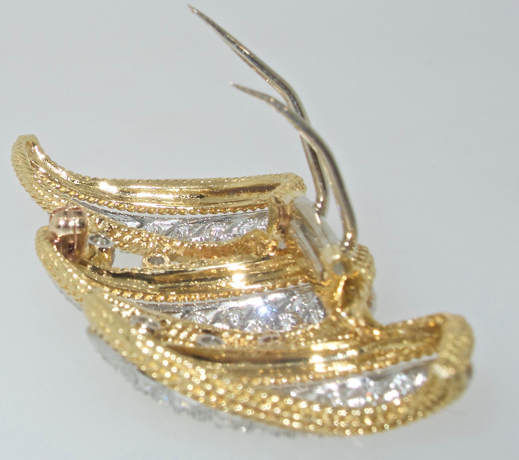 Diamond clip in 18K yellow gold and platinum possessing 4 cts of fine white diamonds - all near colorless (G/H) and very slightly included.  This brooch can also be worn on a necklace of gold or pearls if one wishes.  Just over two inches in length,